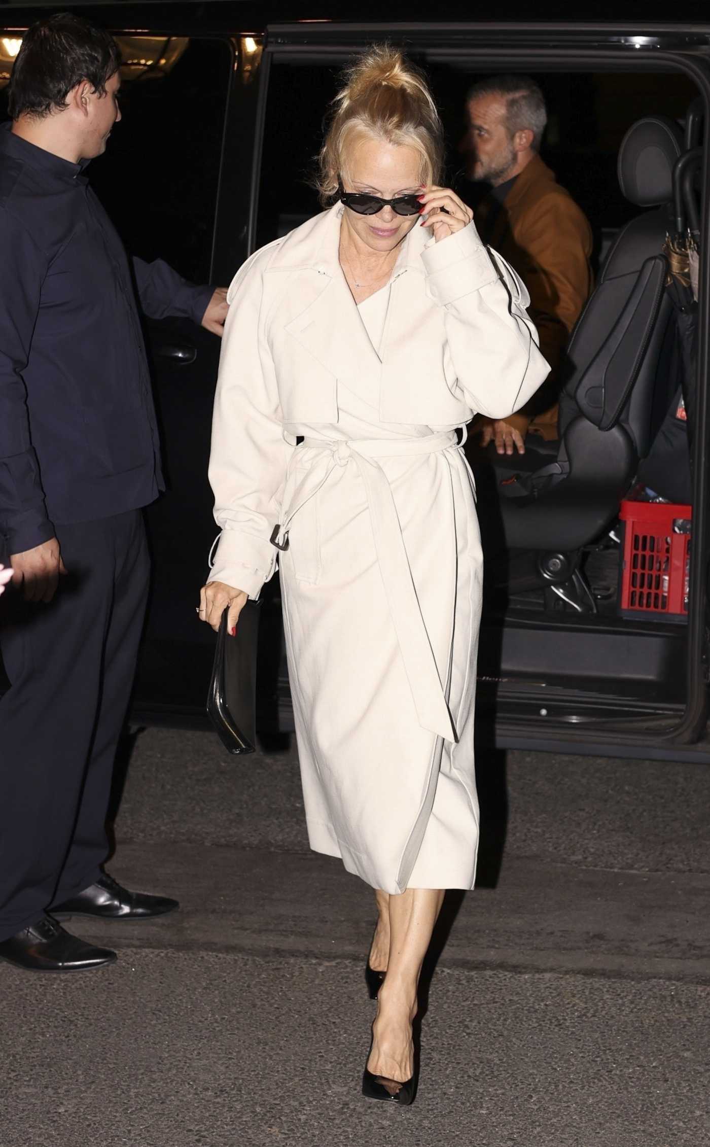 Pamela Anderson in a Beige Coat Leaves the Costes Restaurant with a Friend in Paris 09/25/2023