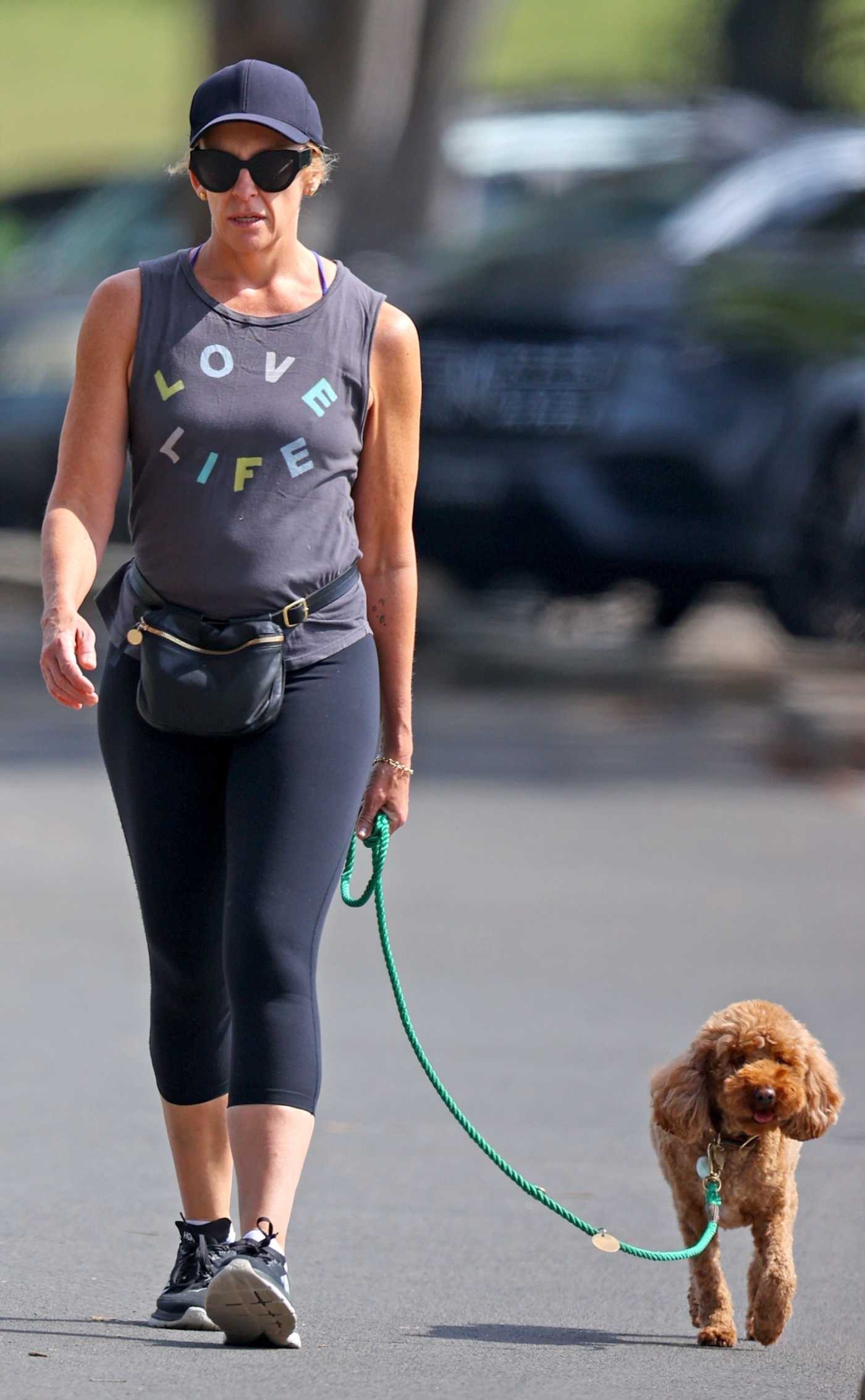 Toni Collette in a Black Cap Walks Her Dog in Sydney 09/15/2023