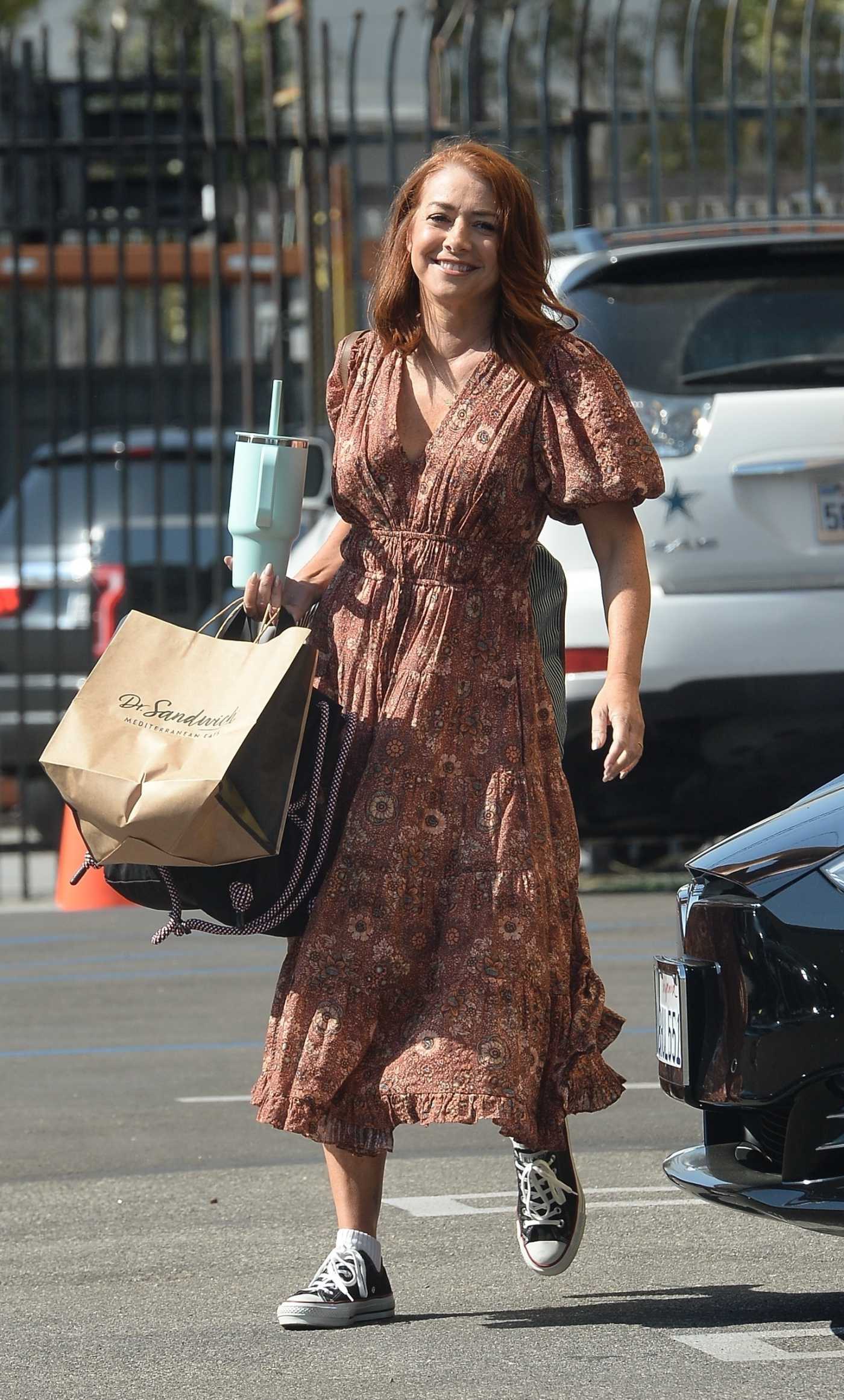 Alyson Hannigan in a Brown Floral Dress Arrives at Dancing With The Stars Studio for Practice in Los Angeles 10/26/2023