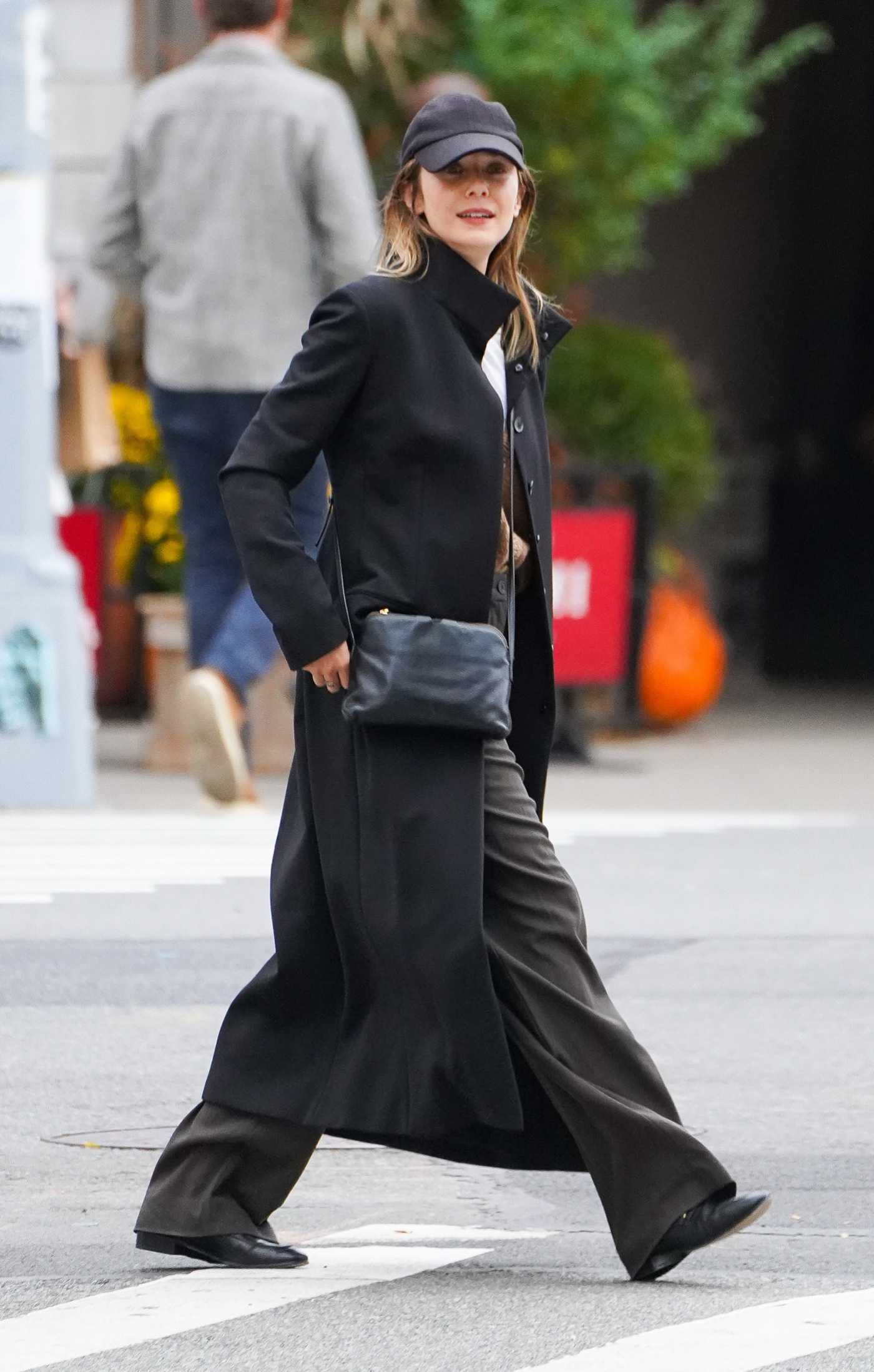 Elizabeth Olsen in a Black Coat Was Seen Out with Robbie Arnett in New York 10/19/2023