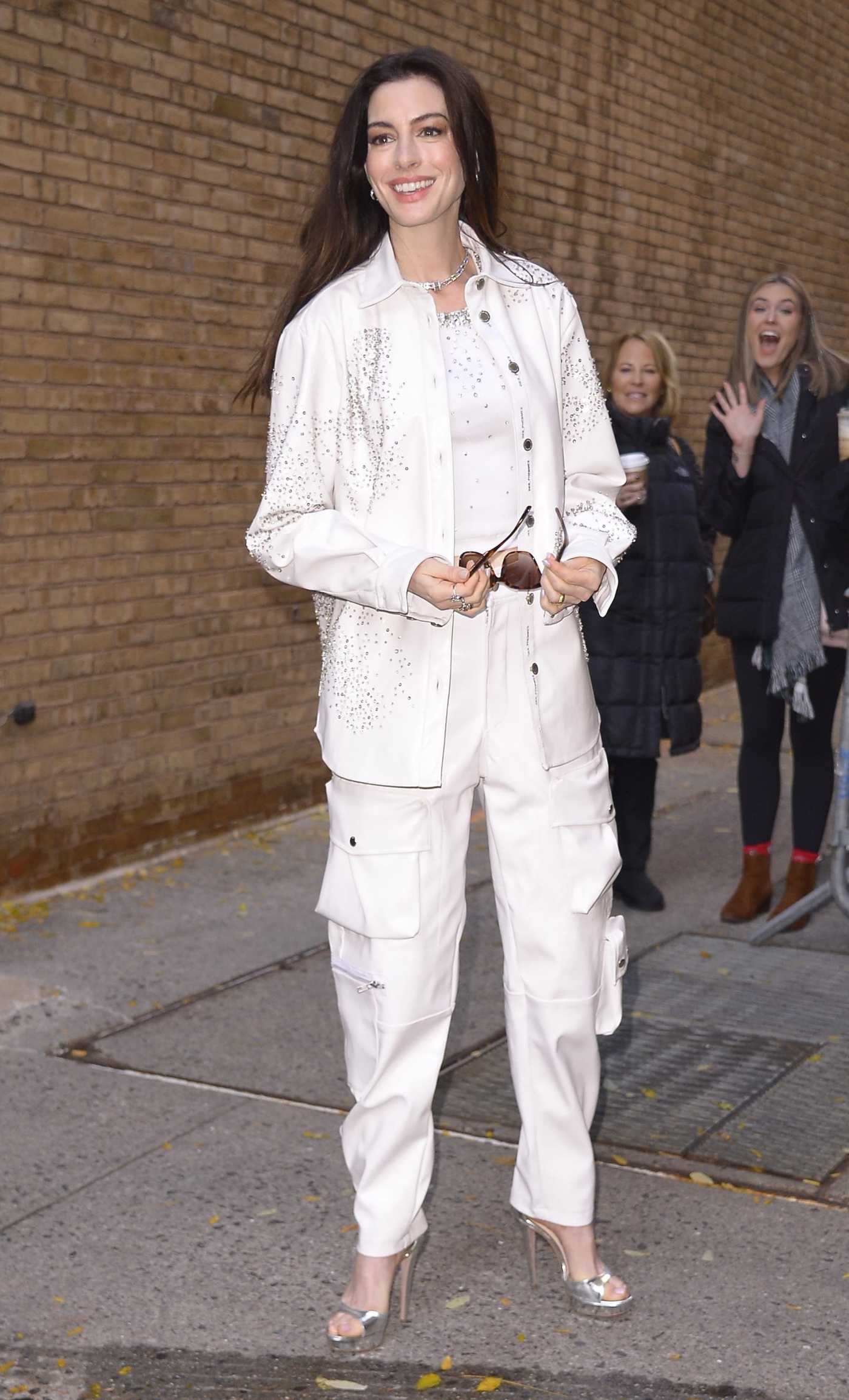 Anne Hathaway in a White Pantsuit Arrives for a Taping of Live with Kelly and Mark in New York 11/27/2023