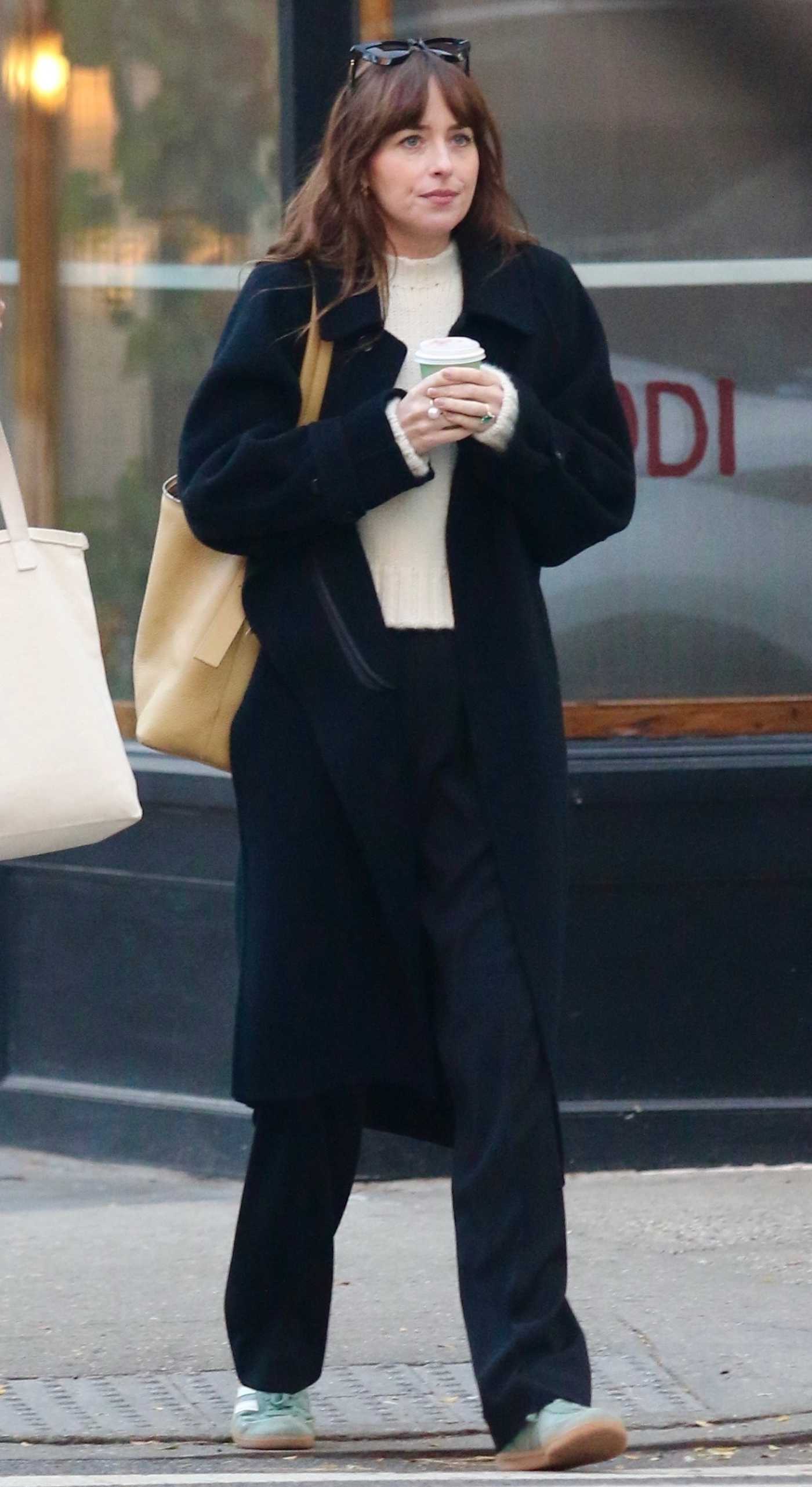 Dakota Johnson in a Black Coat Takes a Relaxed Stroll with a Friend in Manhattan's West Village in New York City 11/16/2023