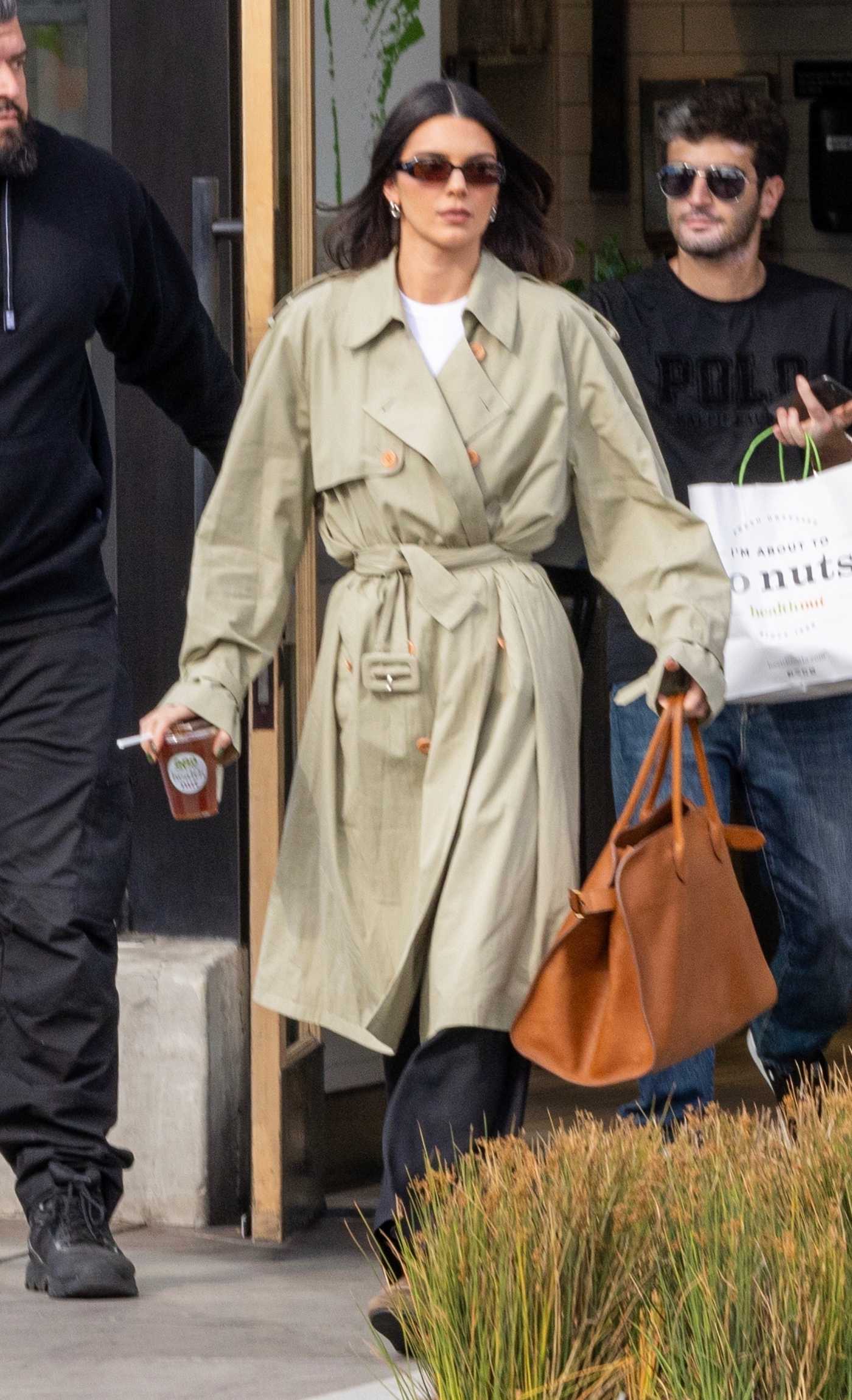 Kendall Jenner in a Beige Trench Coat Was Seen Stopping at Health Nut in Los Angeles 11/13/2023