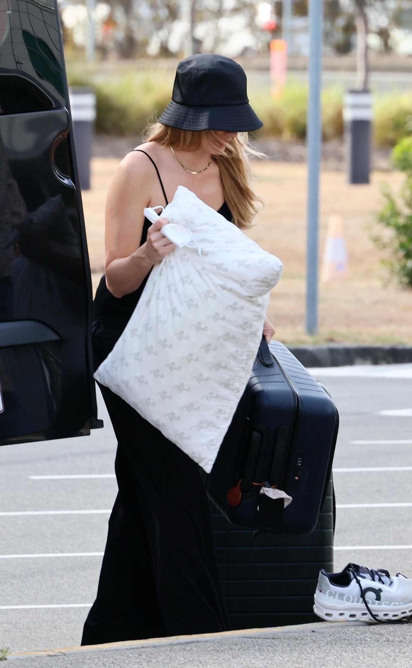 Margot Robbie in a Black Top Arrives at the Airport in Brisbane 11/05/2023