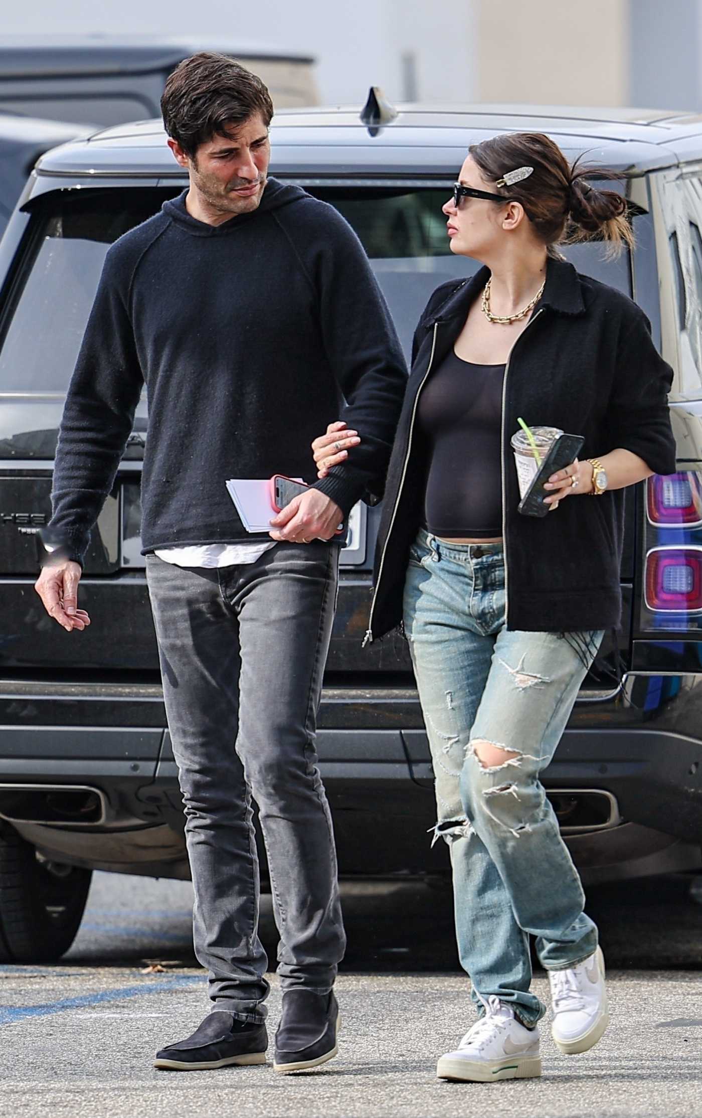 Ashley Benson in a Blue Ripped Jeans Was Seen Out with Her Husband Brandon Davis in Beverly Hills 12/27/2023