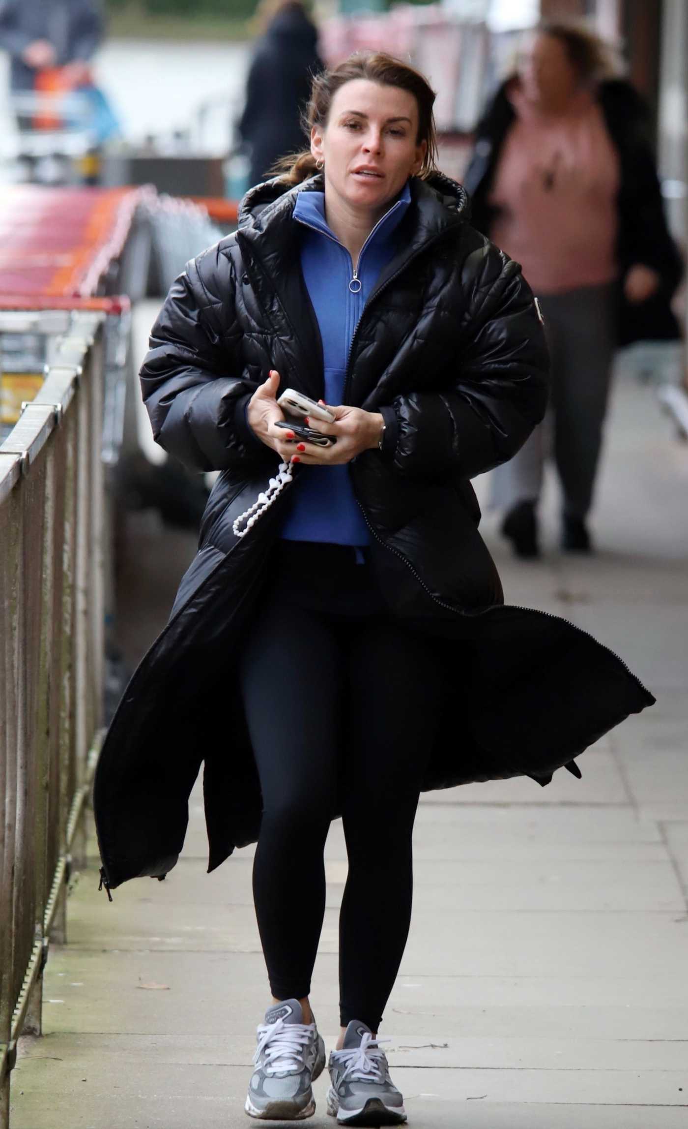 Coleen Rooney in a Black Puffer Coat Getting Some Cash Out in Wilmslow 01/22/2024