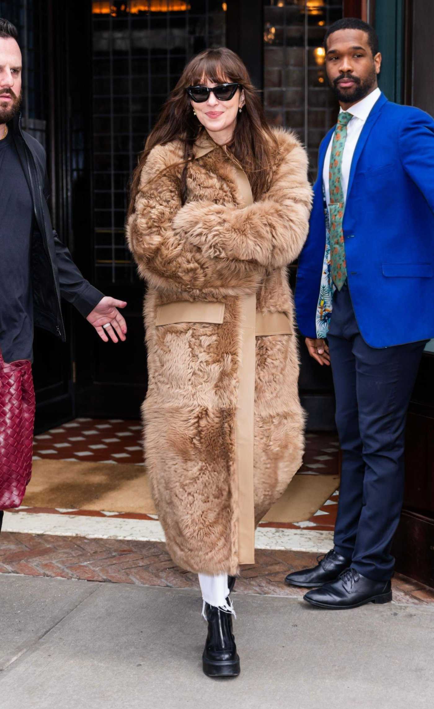 Dakota Johnson in a Tan Fur Coat Leaves Her Hotel in Tribeca in New York 01/27/2024