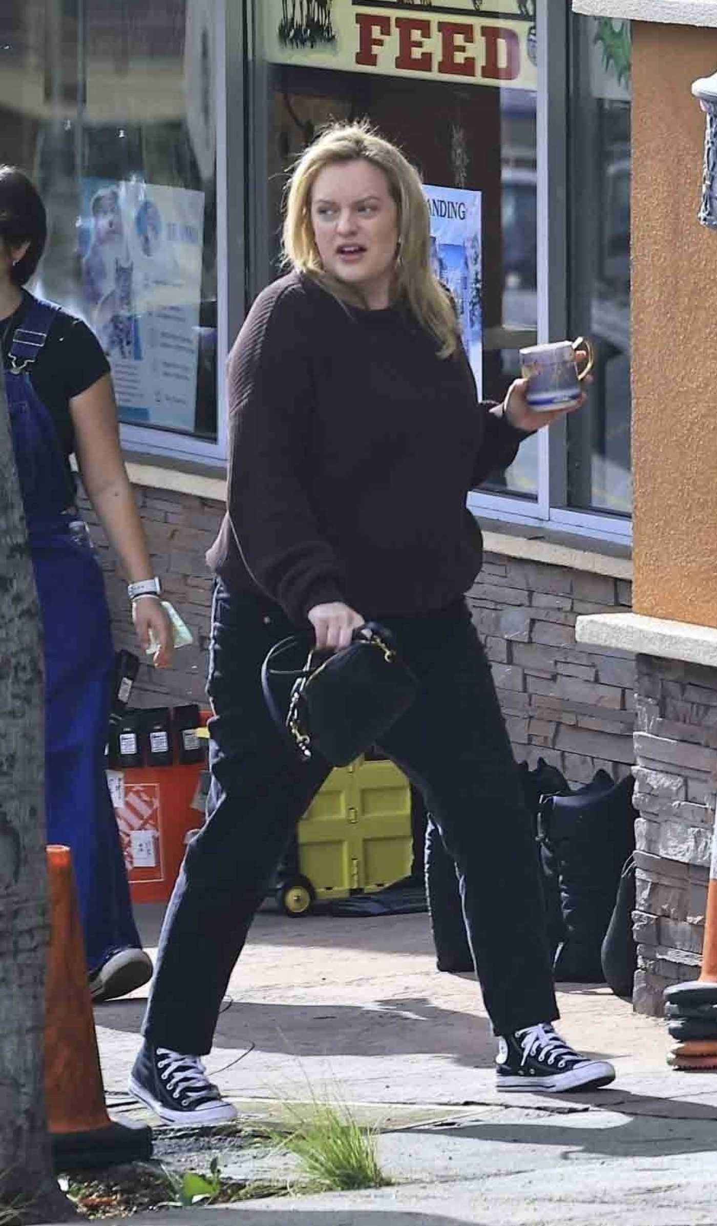 Elisabeth Moss in a Black Sweater Was Spotted Filming of the Shell  with the Crew in Los Angeles 01/03/2024