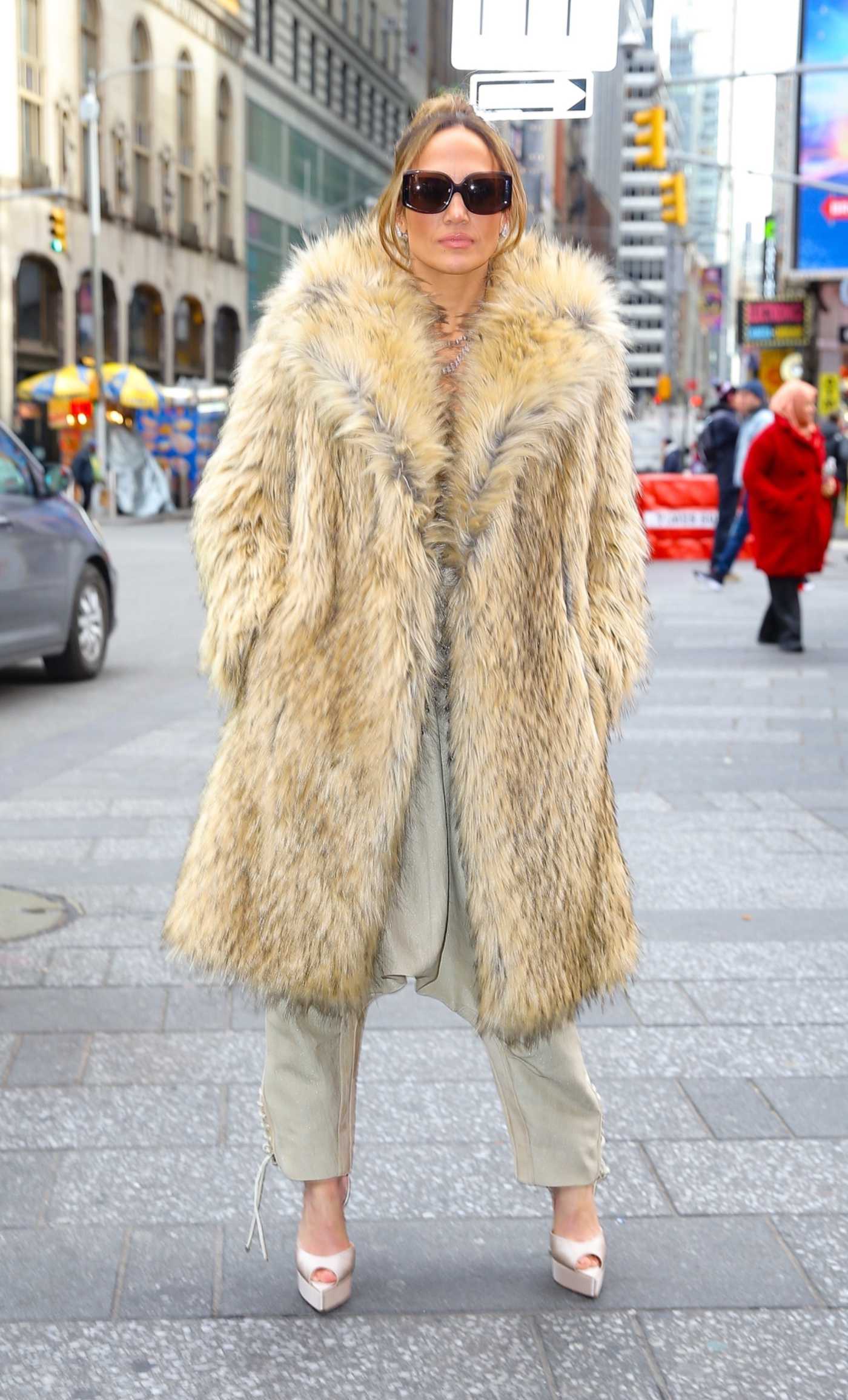 Jennifer Lopez in a Beige Fur Coat Promotes This Is Me... Now the Tour at Times Square in New York City 02/15/2024
