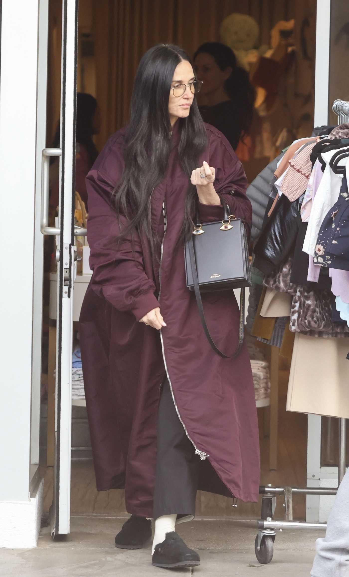 Demi Moore in a Burgundy Coat Was Seen Shopping at English Rabbit in Beverly Hills 03/29/2024