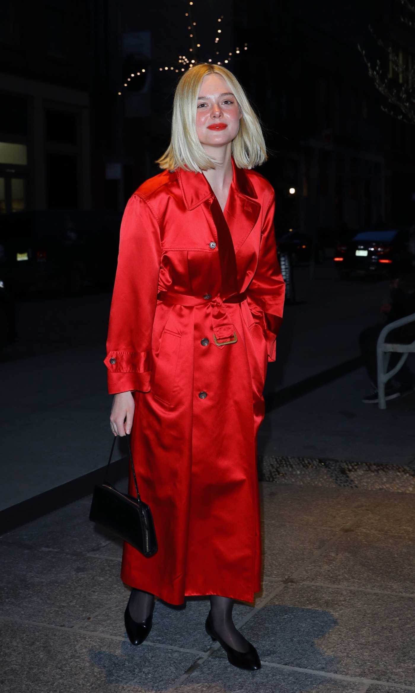 Elle Fanning in a Red Trench Coat Arrives at the Crosby Hotel in New York 03/26/2024