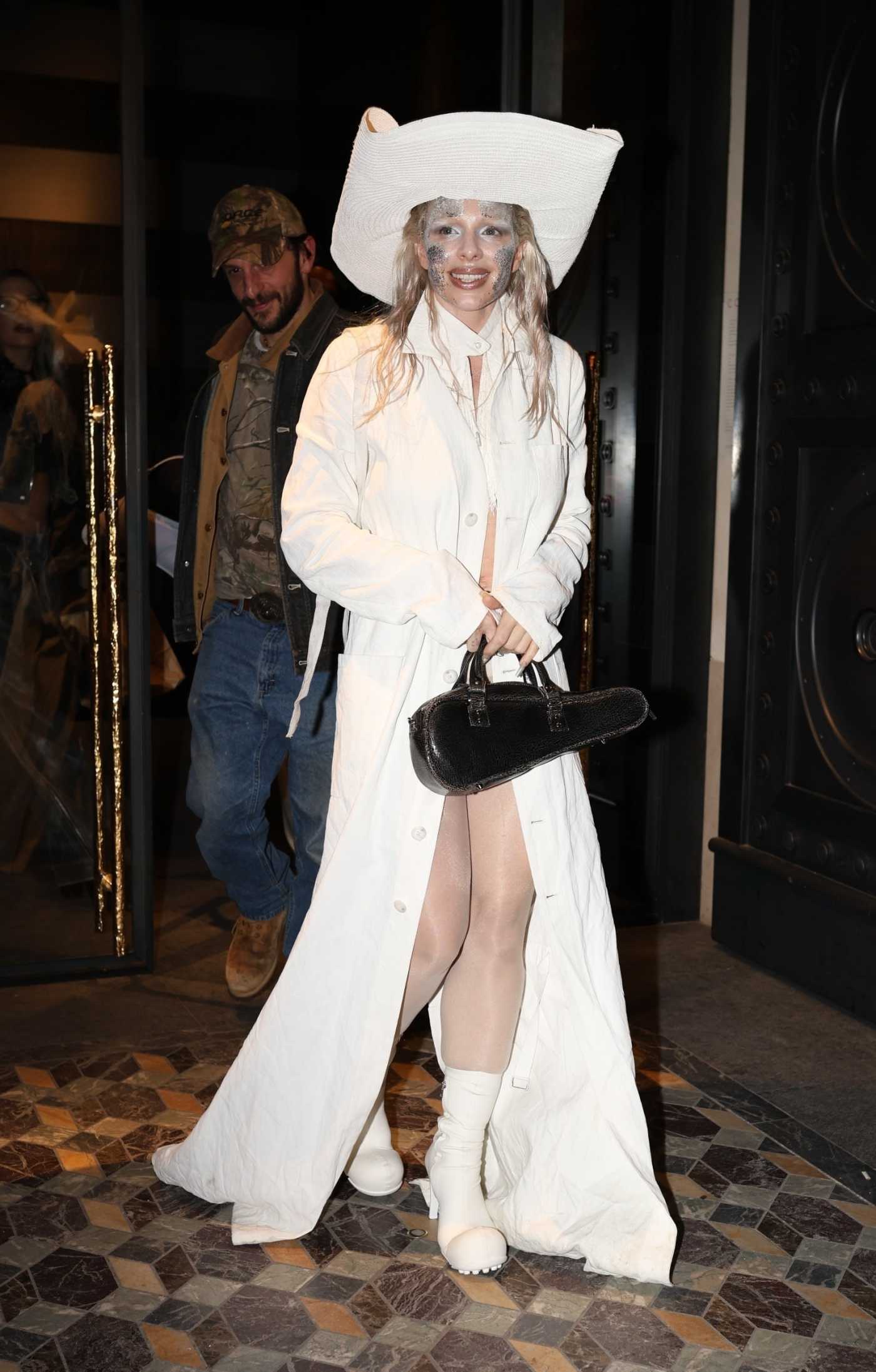 Julia Fox in a White Trench Coat Leaves the Iconic Hotel Costes During 2024 Paris Fashion Week in Paris 03/03/2024