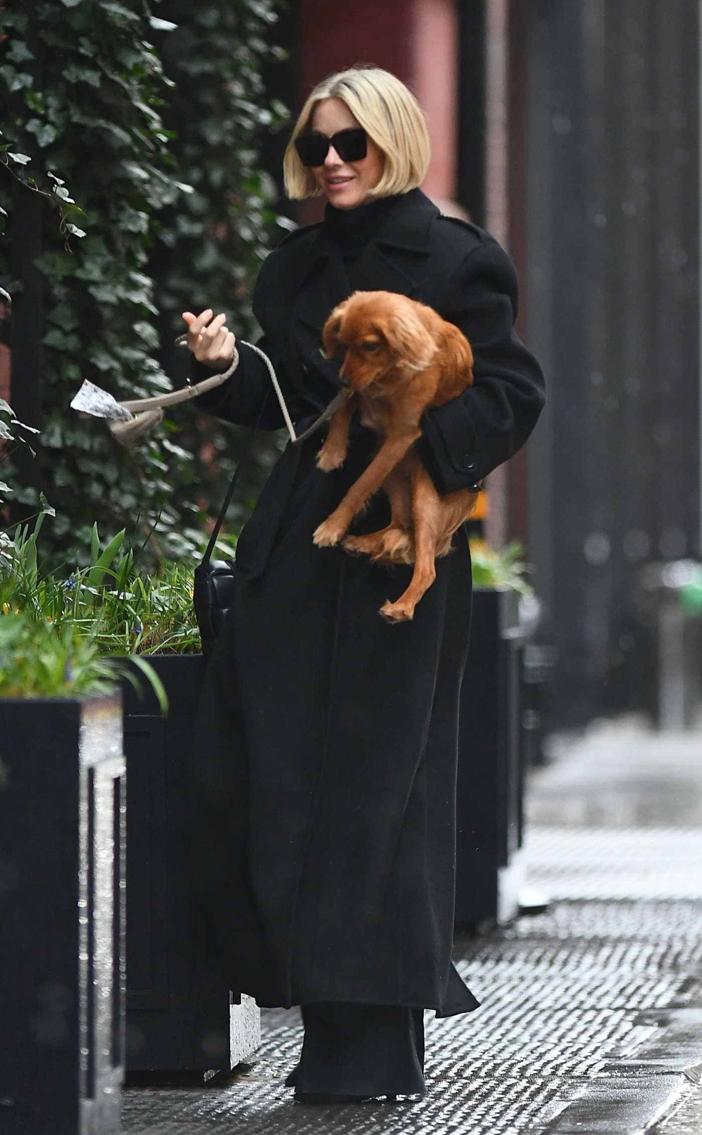 Julianne Hough in a Black Coat Was Spotted with Her Dog in SoHo in New York 03/23/2024