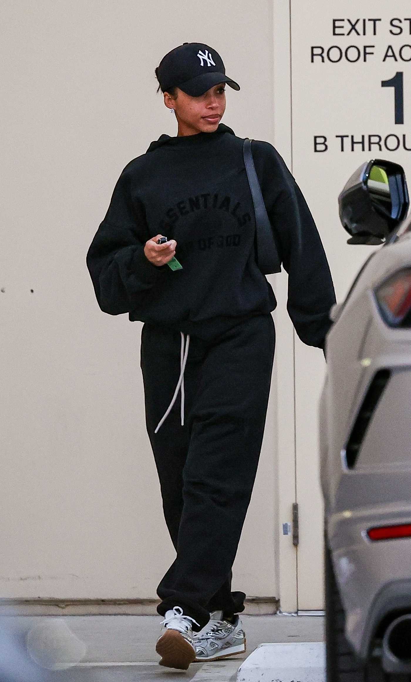 Lori Harvey in a Black Sweatsuit Leaves the Bottega Veneta in Los Angeles 03/27/2024
