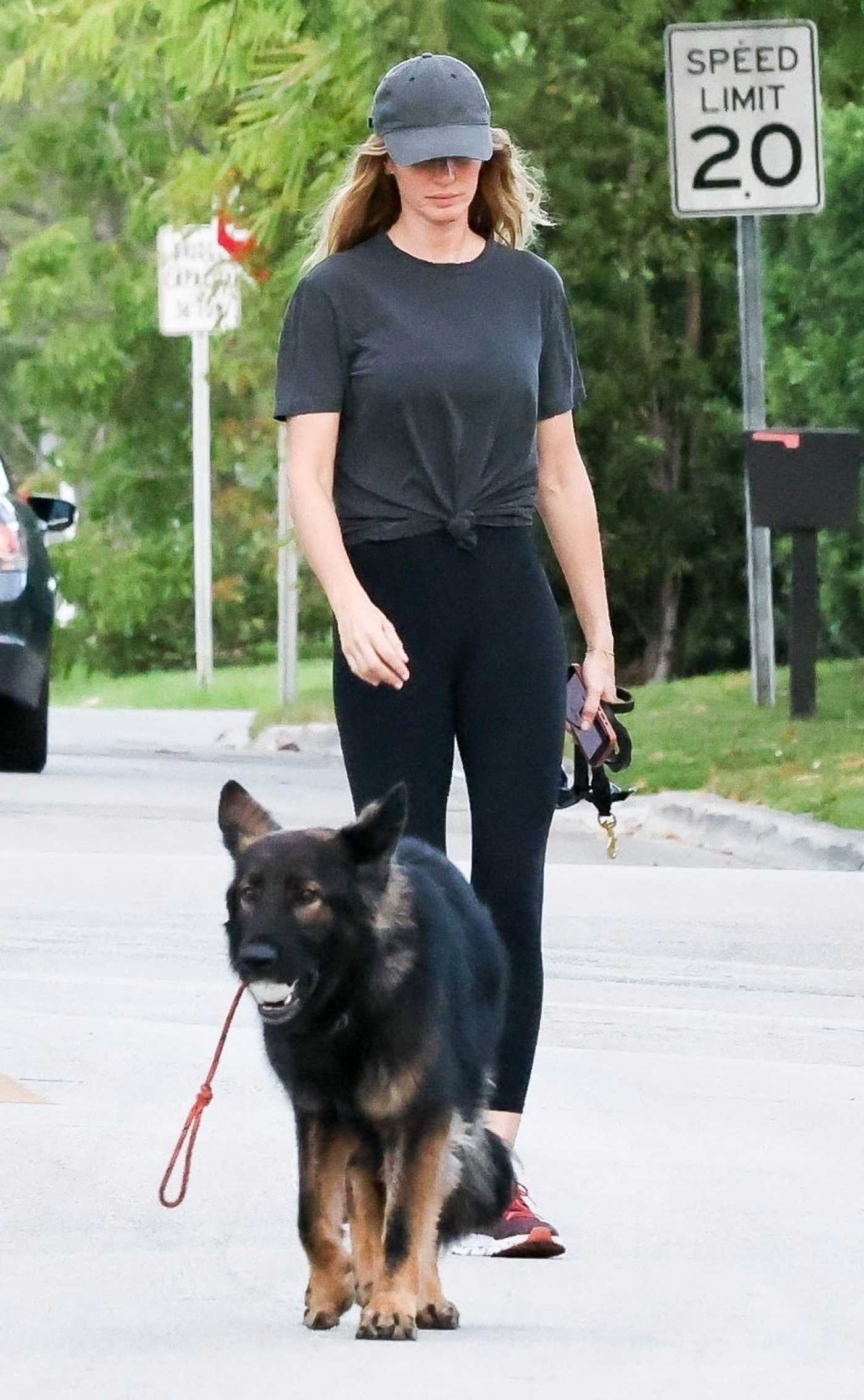 Gisele Bundchen in a Grey Cap Walks Her Dog in Miami 04/16/2024