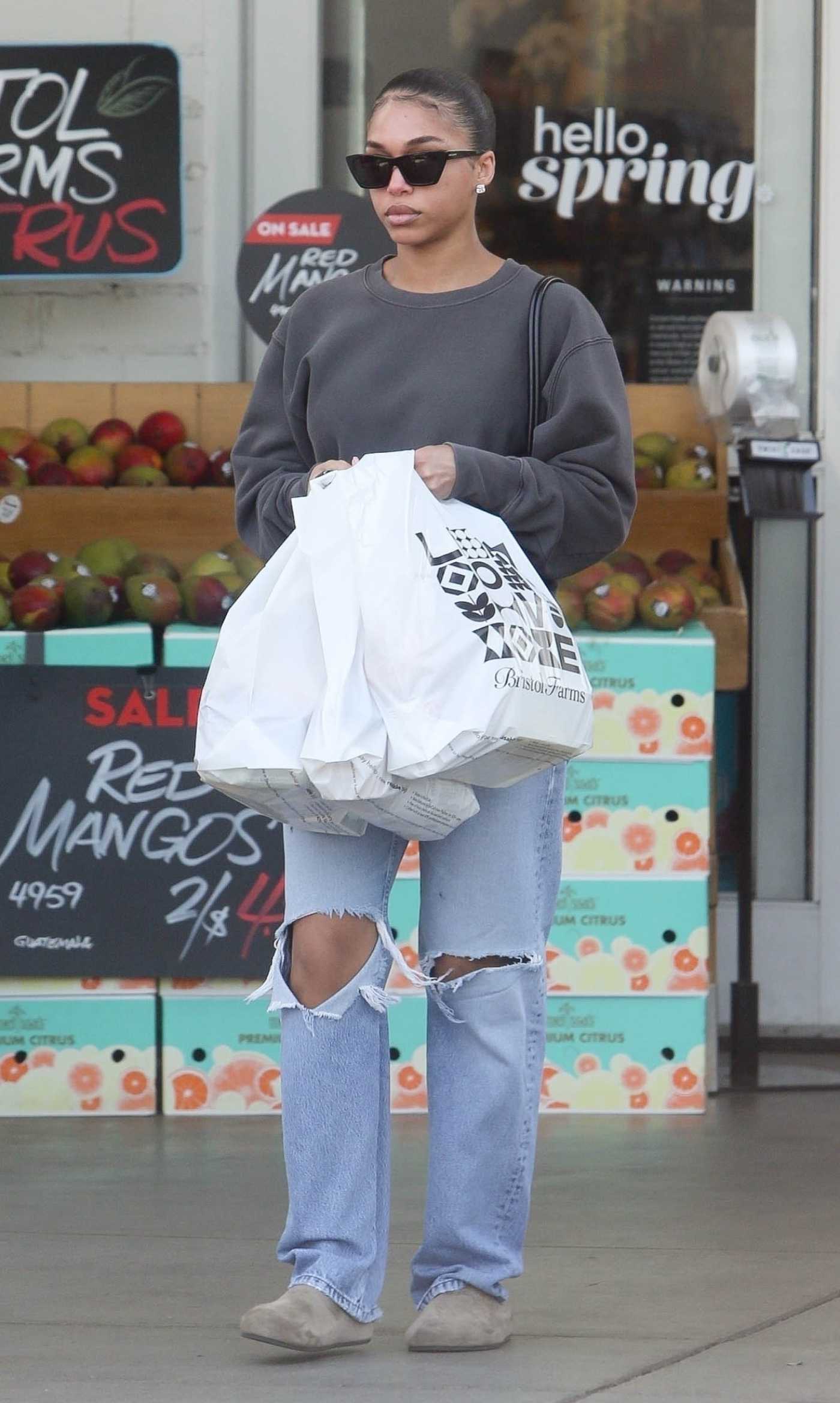 Lori Harvey in a Blue Ripped Jeans Leaves the Bristol Farms in Beverly Hills 05/02/2024