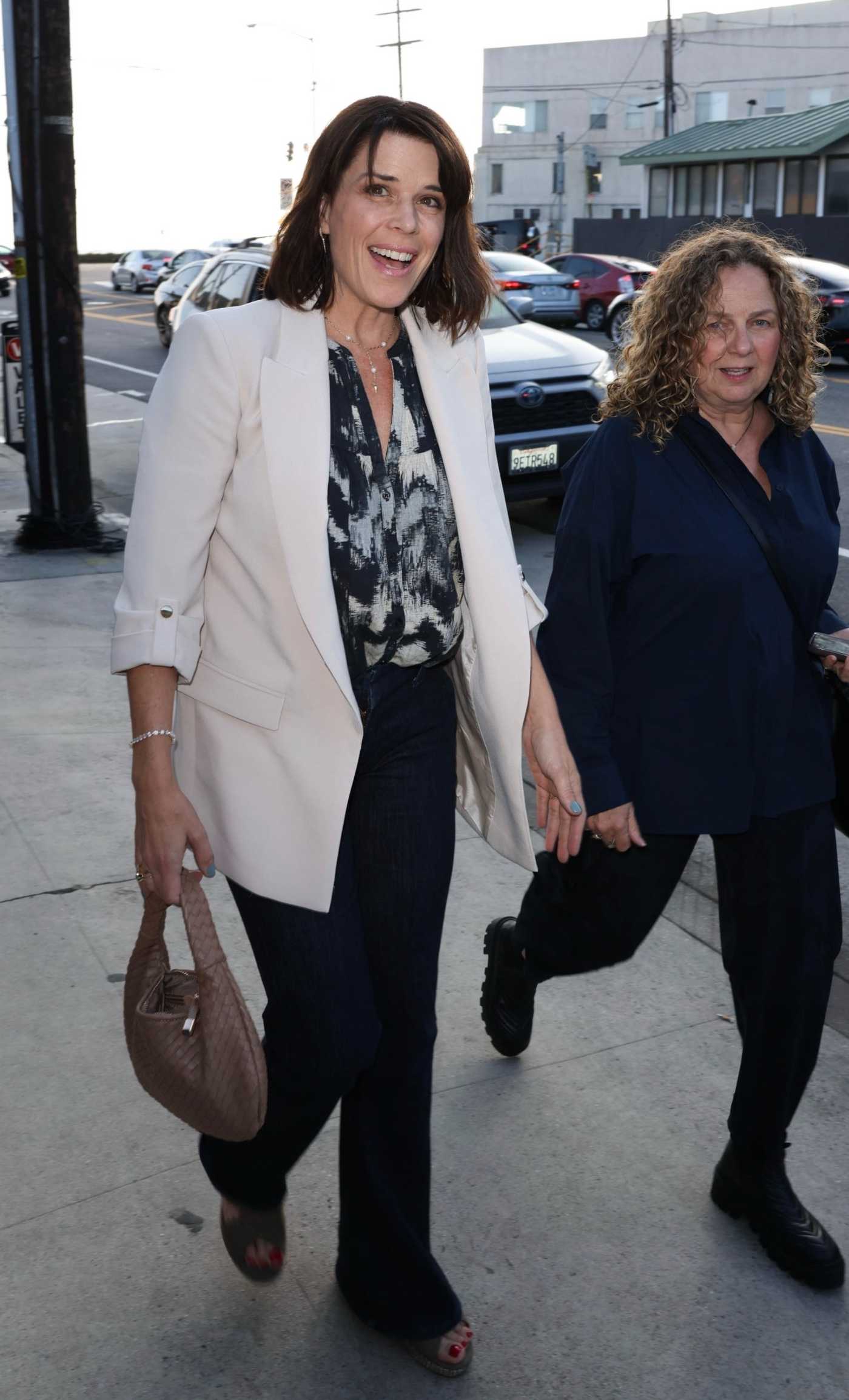 Neve Campbell in a White Blazer Arrives for Dinner with a Friend at Giorgio Baldi in Santa Monica 05/29/2024