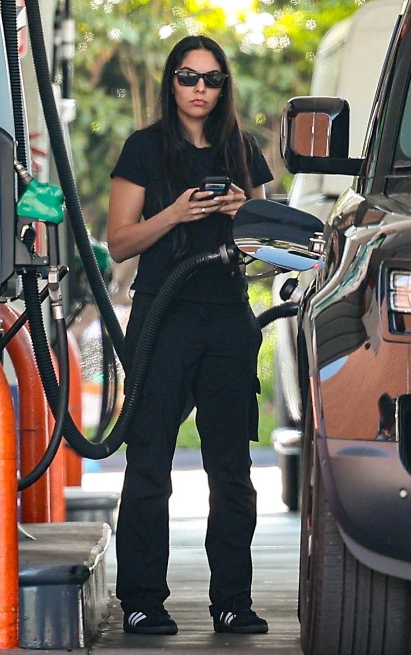 Noor Alfallah in a Black Outfit Stops to Refuel Her Land Rover Defender in Los Angeles 05/29/2024