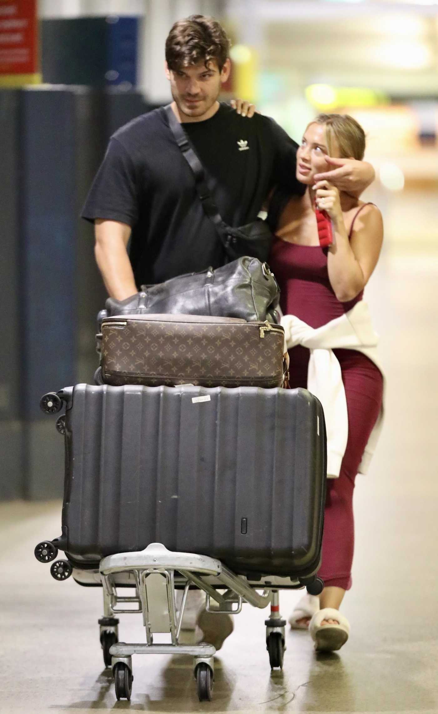 Tammy Hembrow in a White Flip-Flops Arrives at Brisbane Airport with Matt Zukowski in Brisbane 05/26/2024