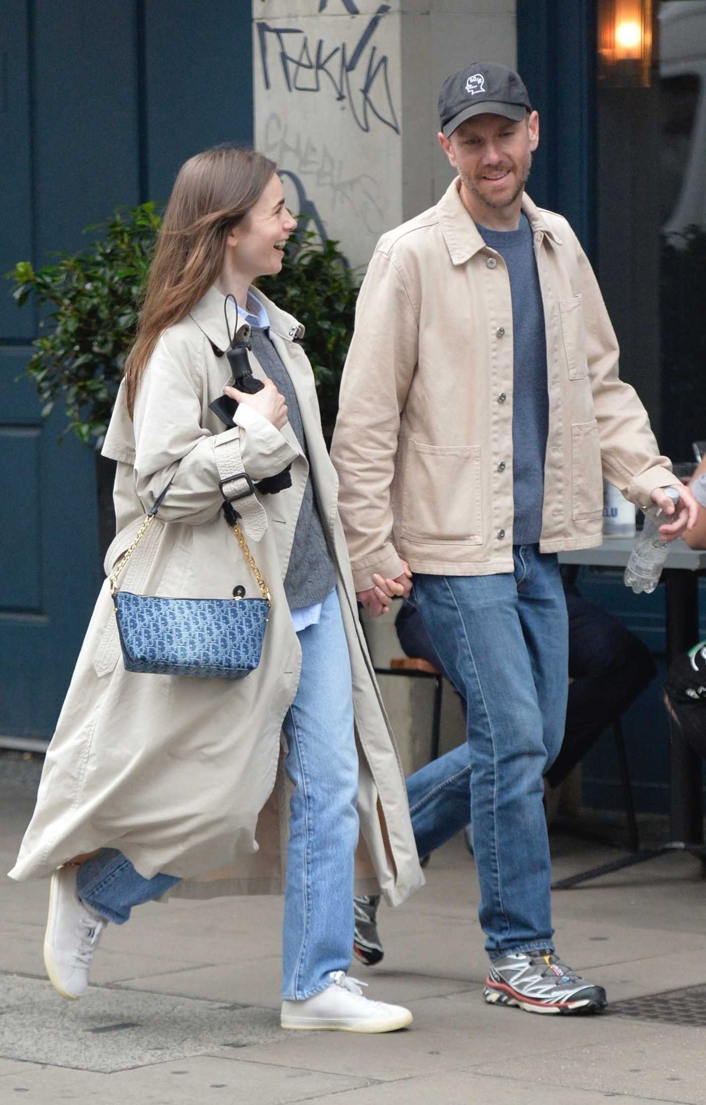 Lily Collins in a Beige Trench Coat Was Seen Out with Charlie McDowell in London 06/04/2024