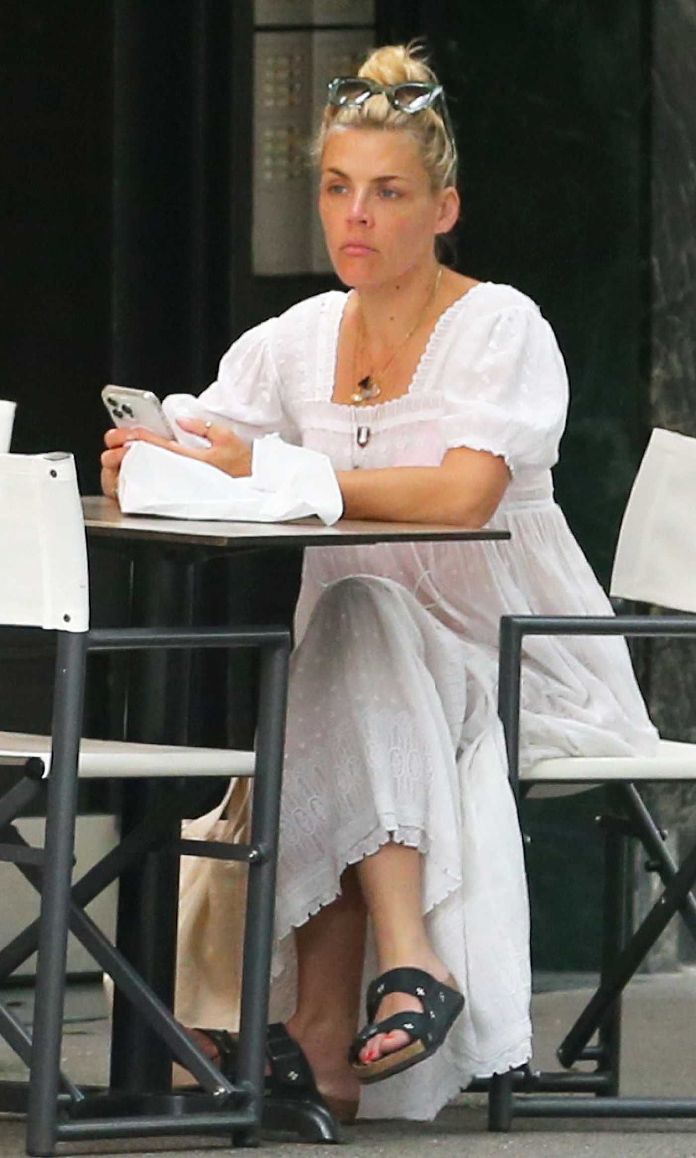 Busy Philipps in a White Maxi Dress Enjoying Breakfast at Sofia's Bagels in New York 07/17/2024