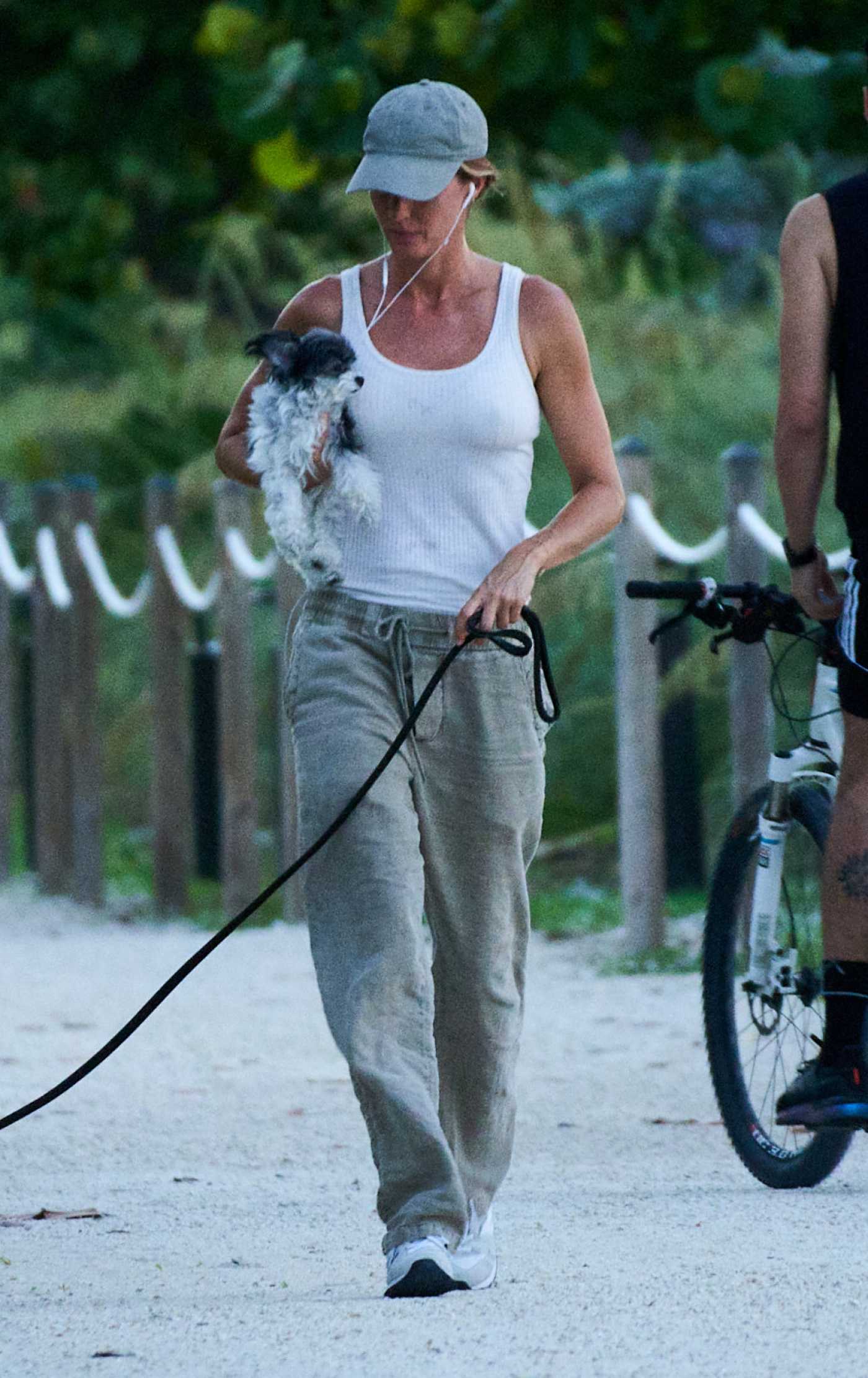 Gisele Bundchen in a White Tank Top Walks Her Dog in Miami 07/01/2024