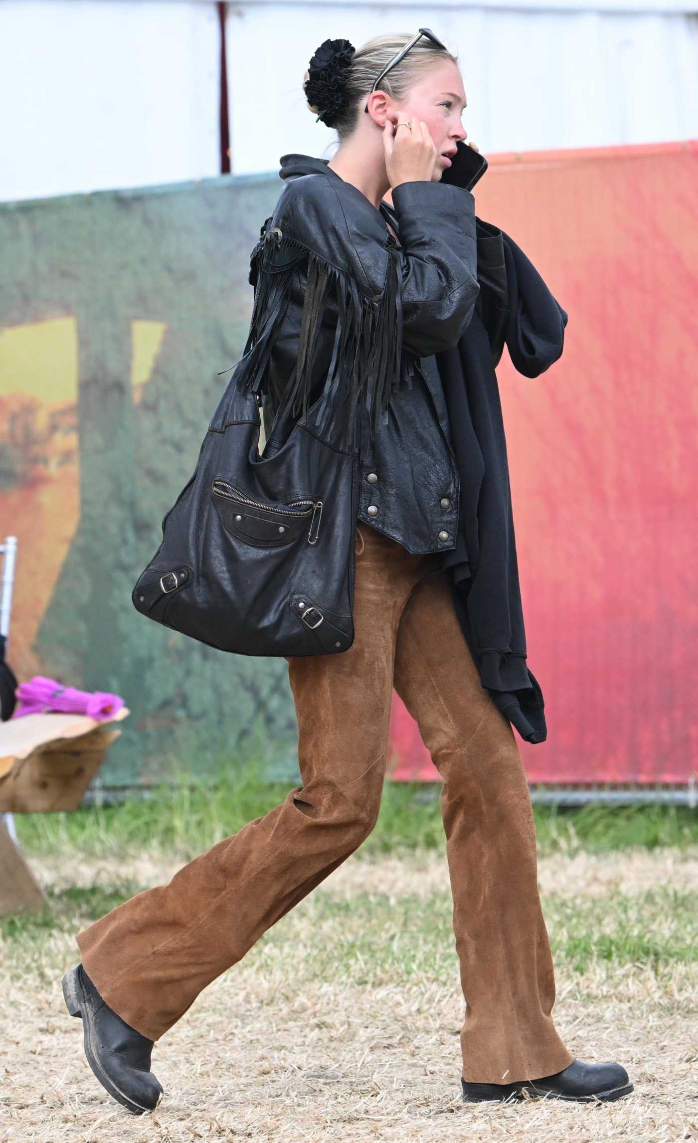 Lila Moss in a Black Leather Jacket Was Seen Enjoying 2024 Glastonbury Music Festival in Glastonbury 06/30/2024