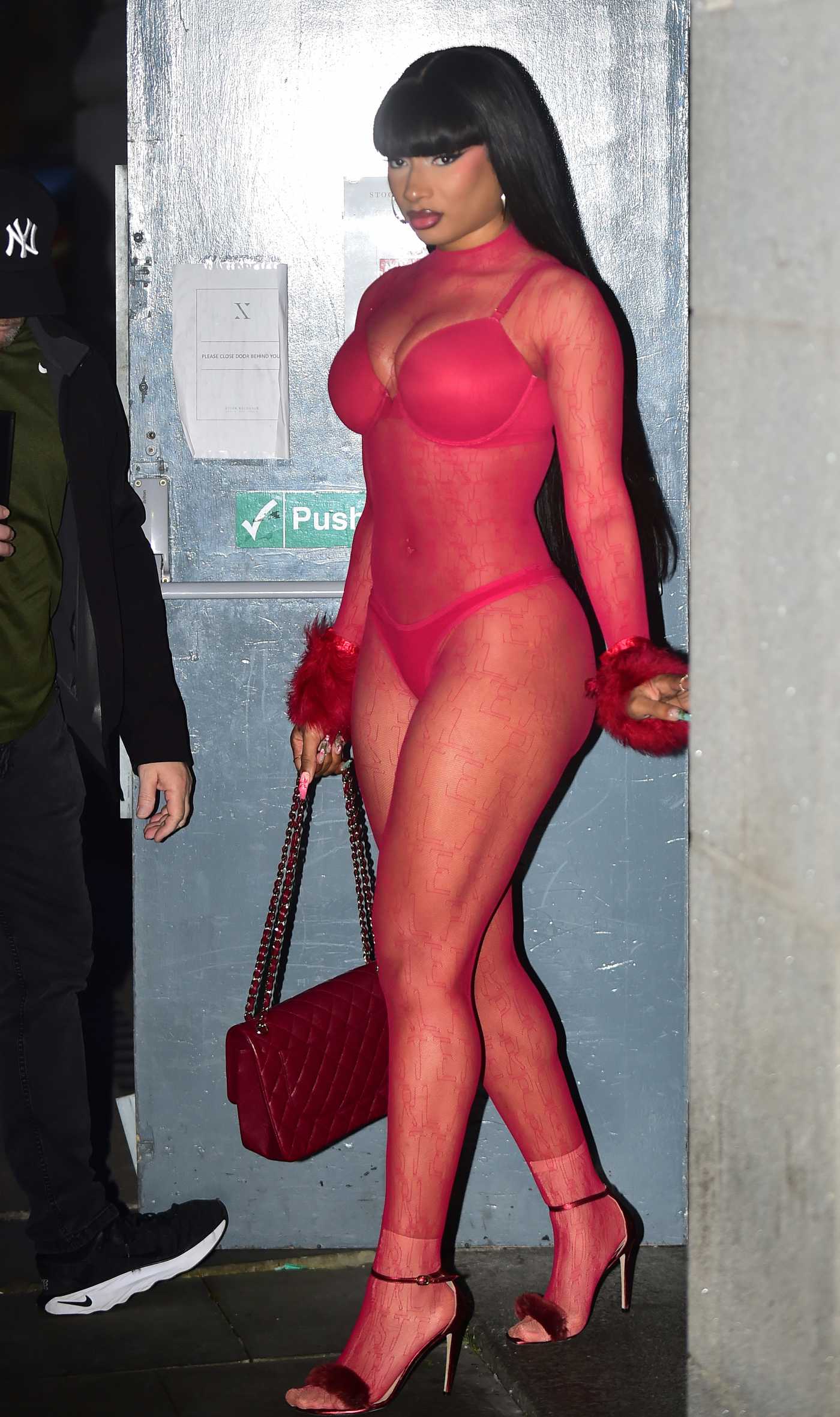 Megan Thee Stallion in a Red See-Through Jumpsuit while Enjoying a Night Out in Manchester 07/13/2024