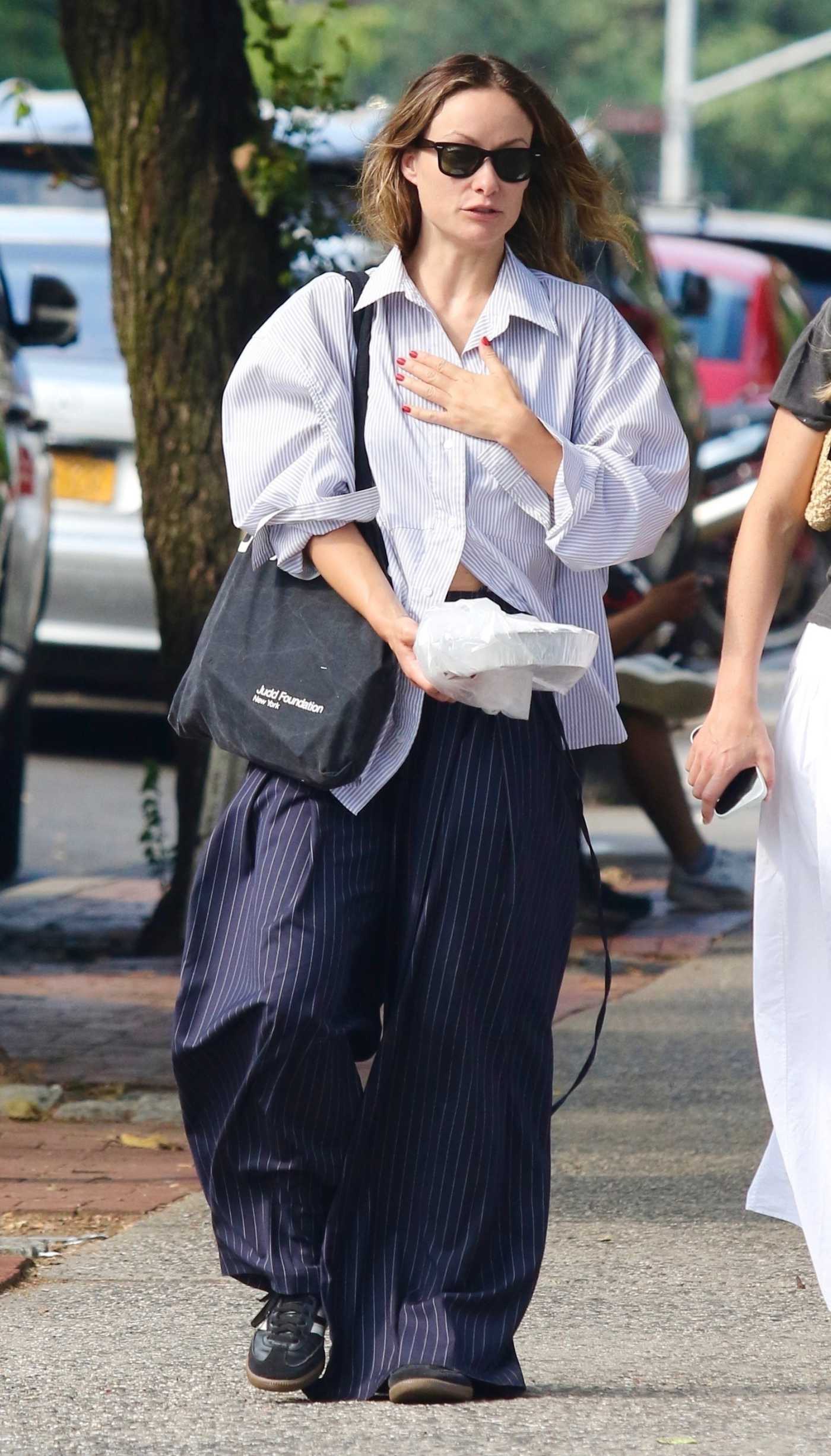 Olivia Wilde in a White Striped Shirt Was Seen Out in Manhattan’s SoHo Neighborhood in NYC 07/29/2024