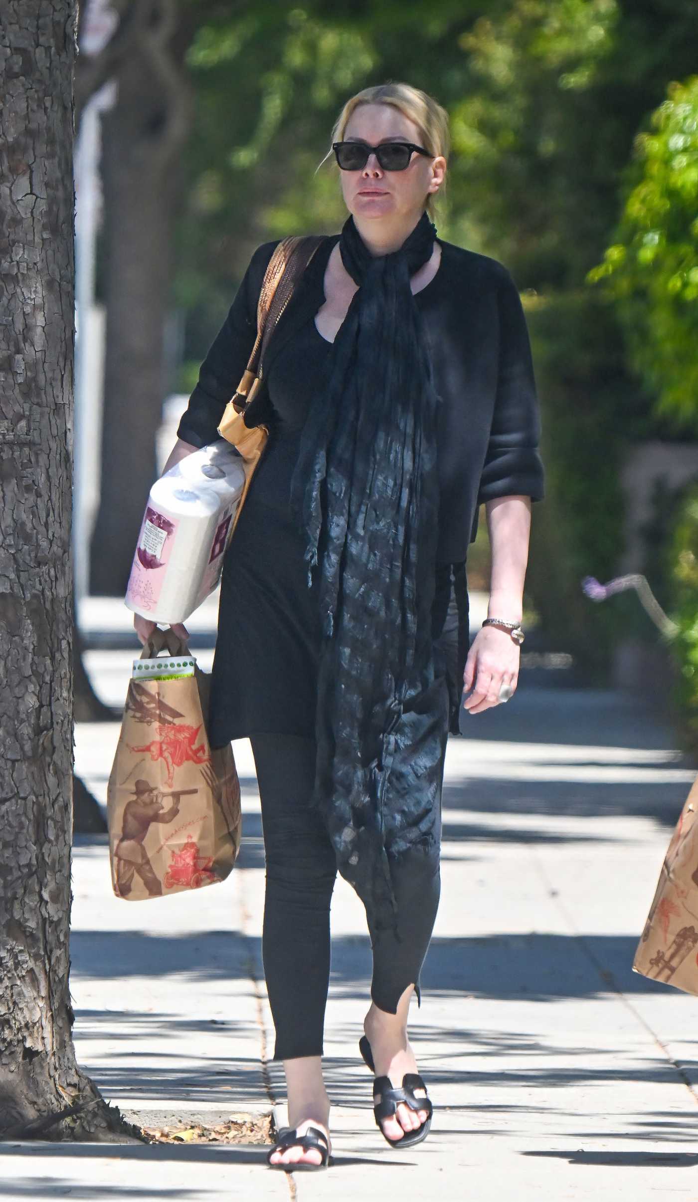 Alice Evans in a Black Dress Steps Out for Some Grocery Shopping at Trader Joe's in Los Angeles 08/26/2024