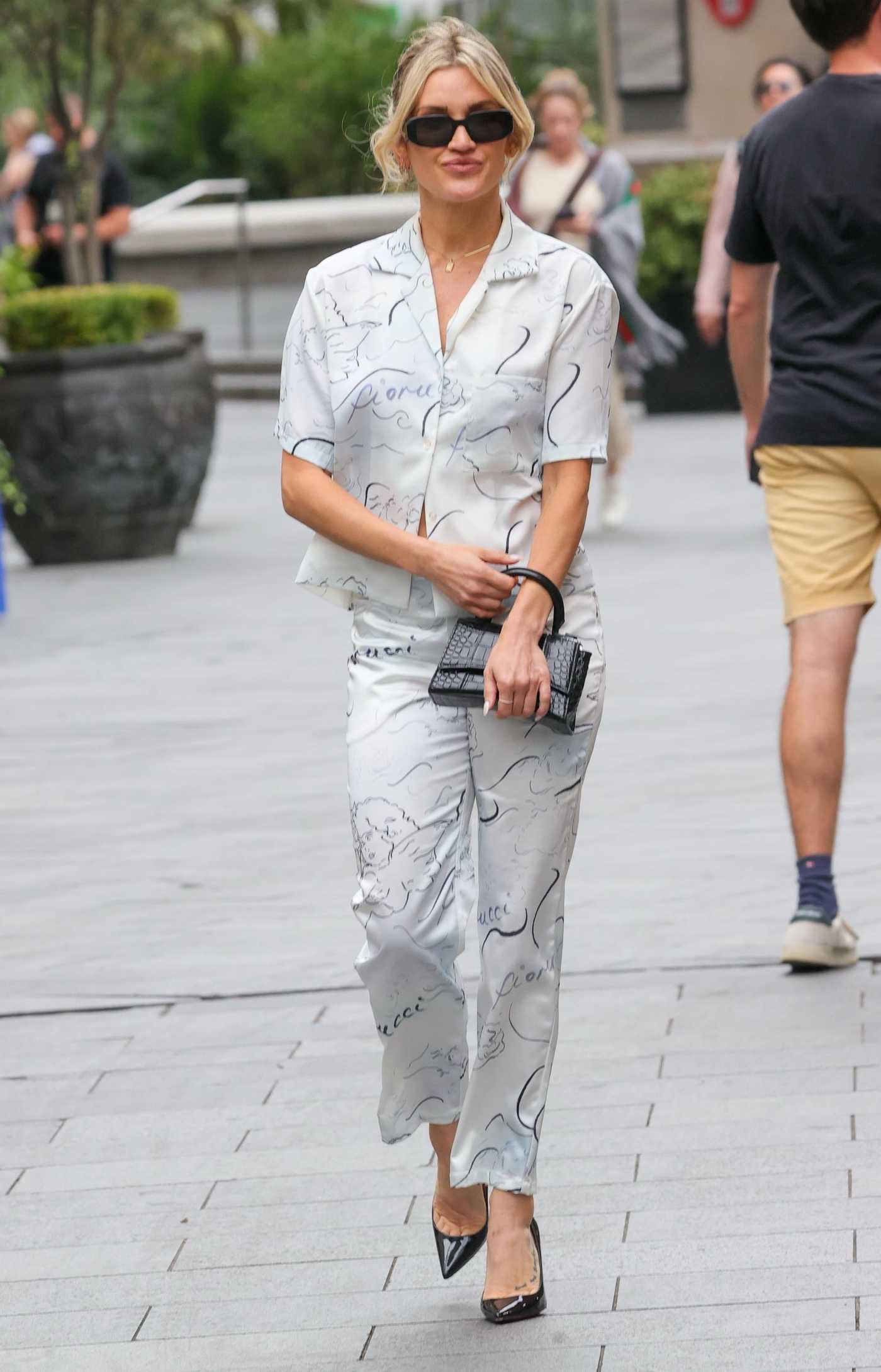 Ashley Roberts in a White Patterned Pantsuit Leaves the Heart Radio in London 08/06/2024