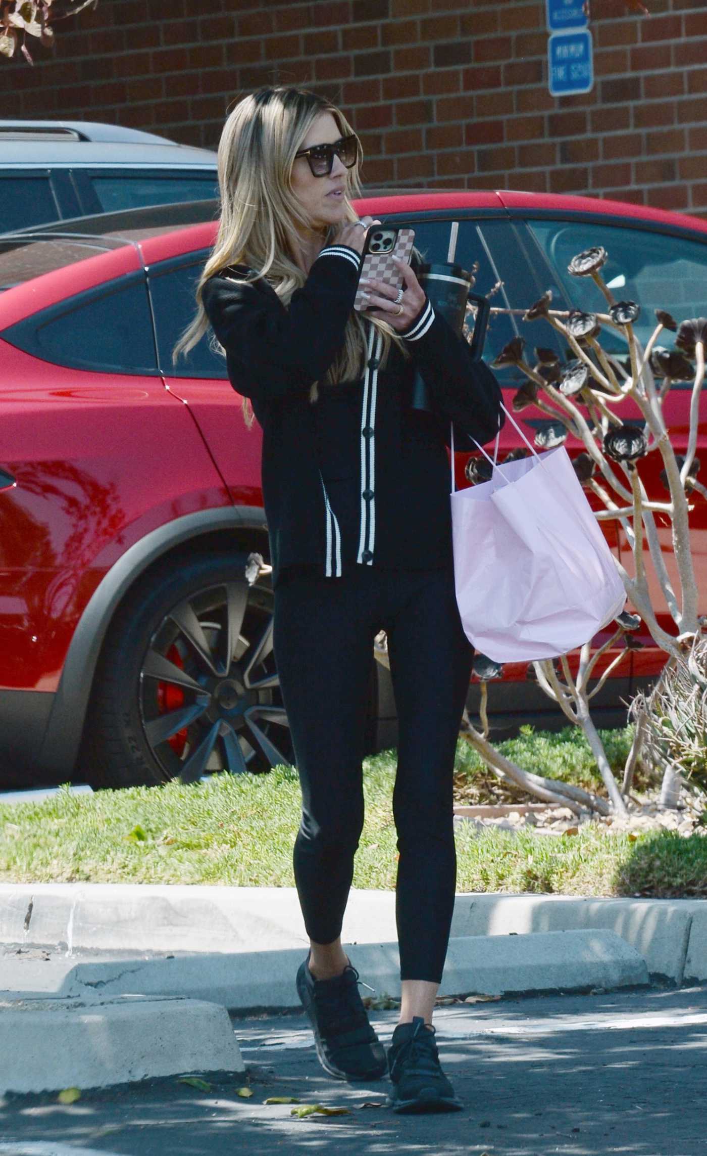 Christina Hall in a Black Sneakers Leaves an Attorney's Office at Dearmey Law in Tustin 07/30/2024