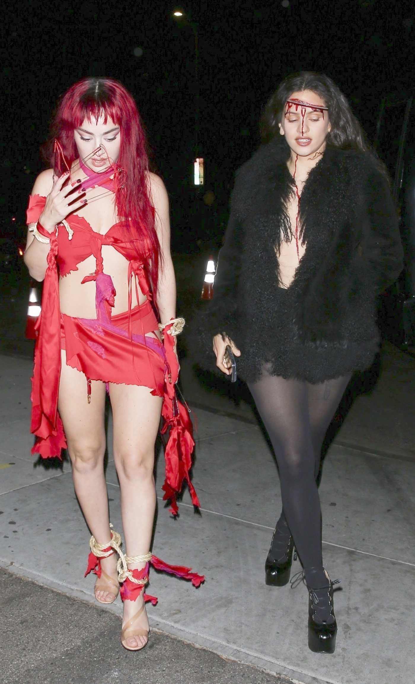 Charli XCX in a Red Ensemble Arrives at Kendall Jenner’s Halloween Party at Chateau Marmont with Rosalia in Los Angeles 10/31/2024