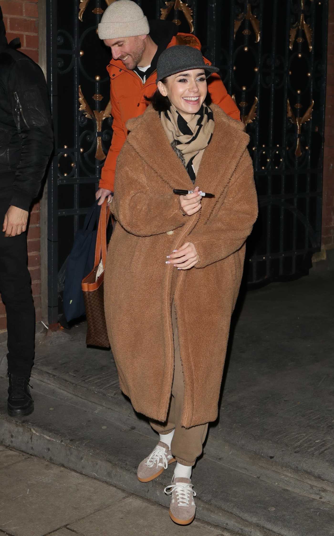 Lily Collins in a Black Cap Leaves the Duke of York Theatre in London 11/21/2024