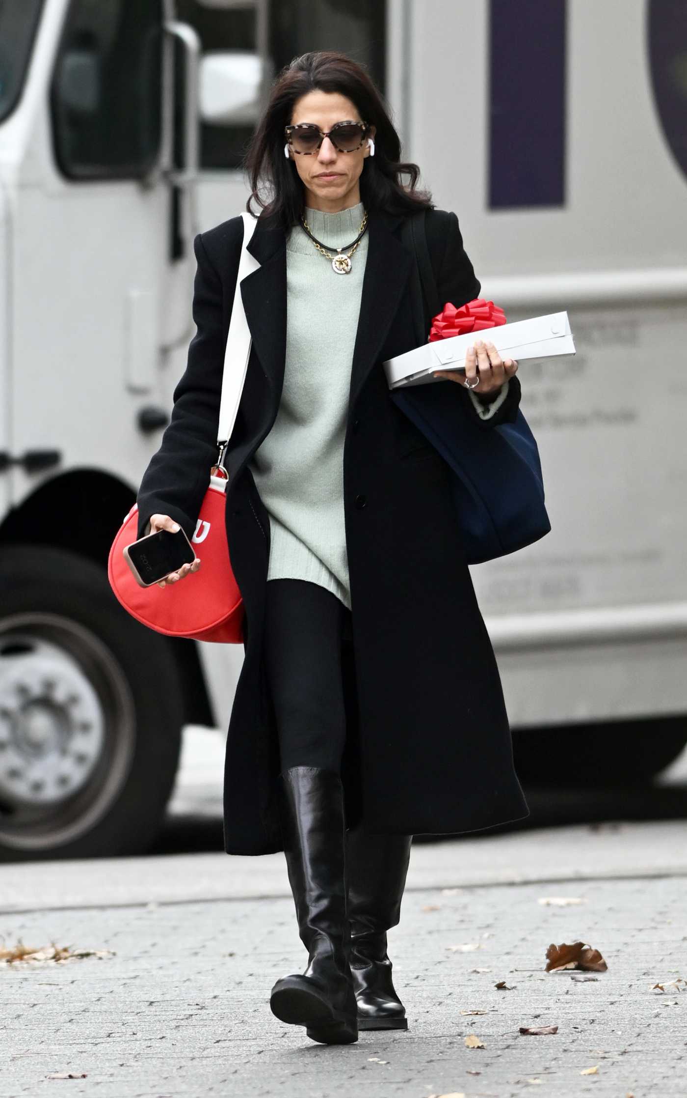 Huma Abedin in a Black Coat Was Spotted with a Christmas Gift in New York 12/19/2024