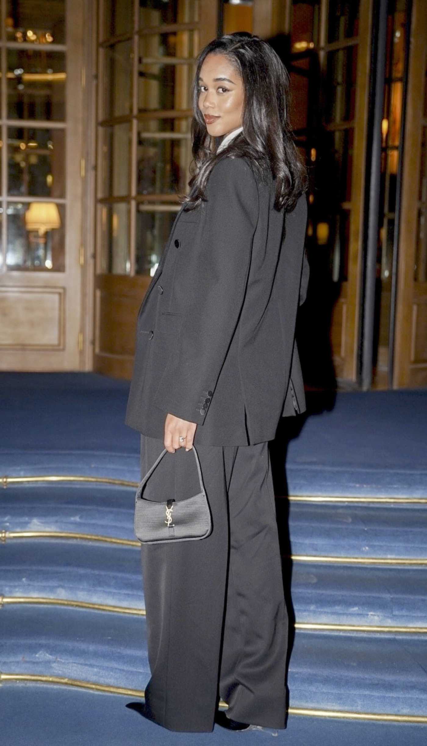 Laura Harrier in a Black Pantsuit Arrives at Her Hotel in Paris 01/28/2025