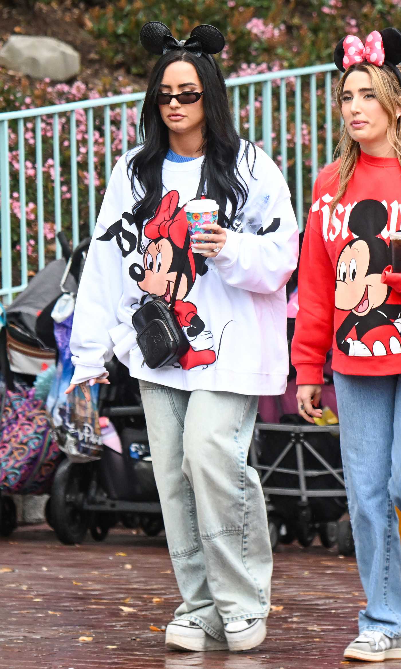 Demi Lovato in a White Oversized Sweatshirt Has a Fun Day with Her Fiancee and Pals at Disneyland in Anaheim 03/18/2025