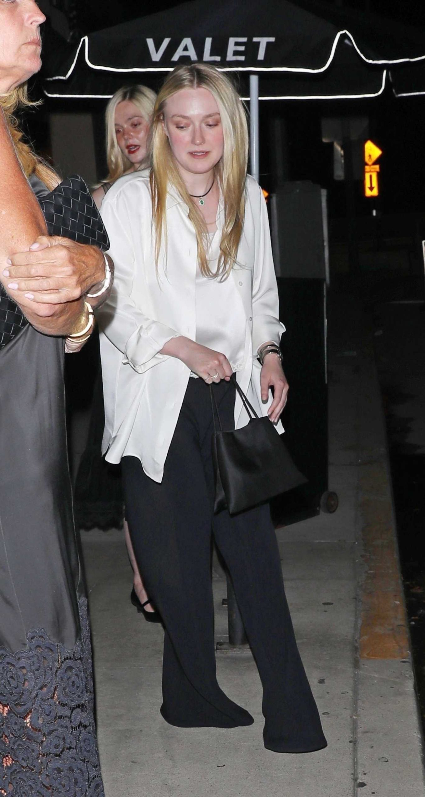 Dakota Fanning in a White Shirt Steps Out for Dinner at Giorgio Baldi in Santa Monica 07/15/2025