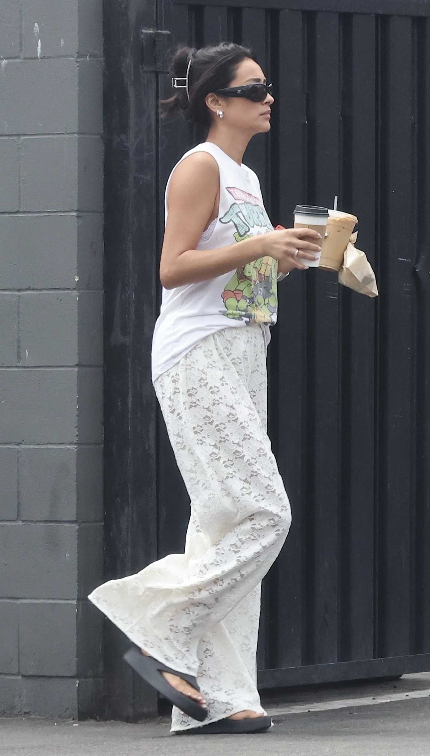 Shay Mitchell in a White Lace Pants Makes a Quick Coffee Run in Los Angeles 08/23/2025