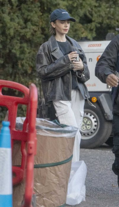 Lily Collins in a Black Leather Jacket