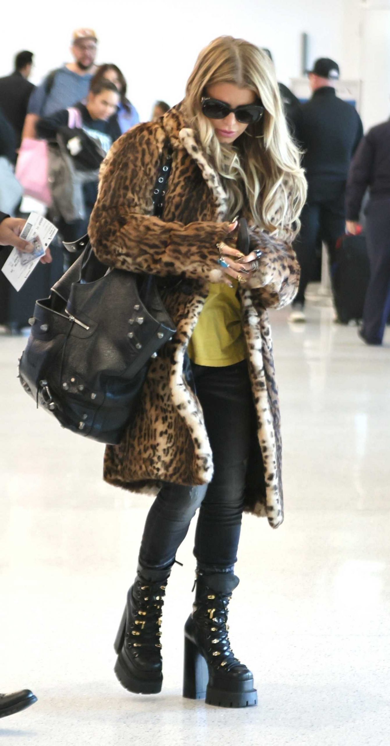 Jessica Simpson in an Animal Print Fur Coat Arrives at LAX Airport in Los Angeles 11/28/2025