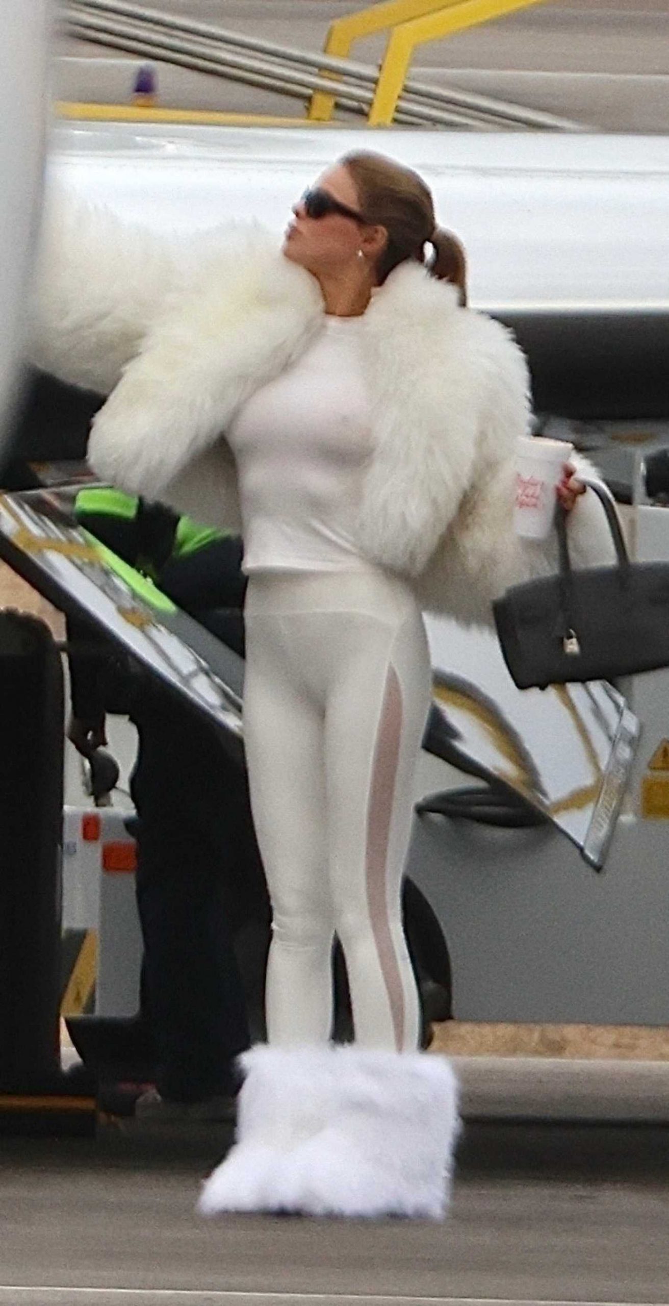 Brooks Nader in a White Fur Jacket Arrives in Aspen 12/23/2025