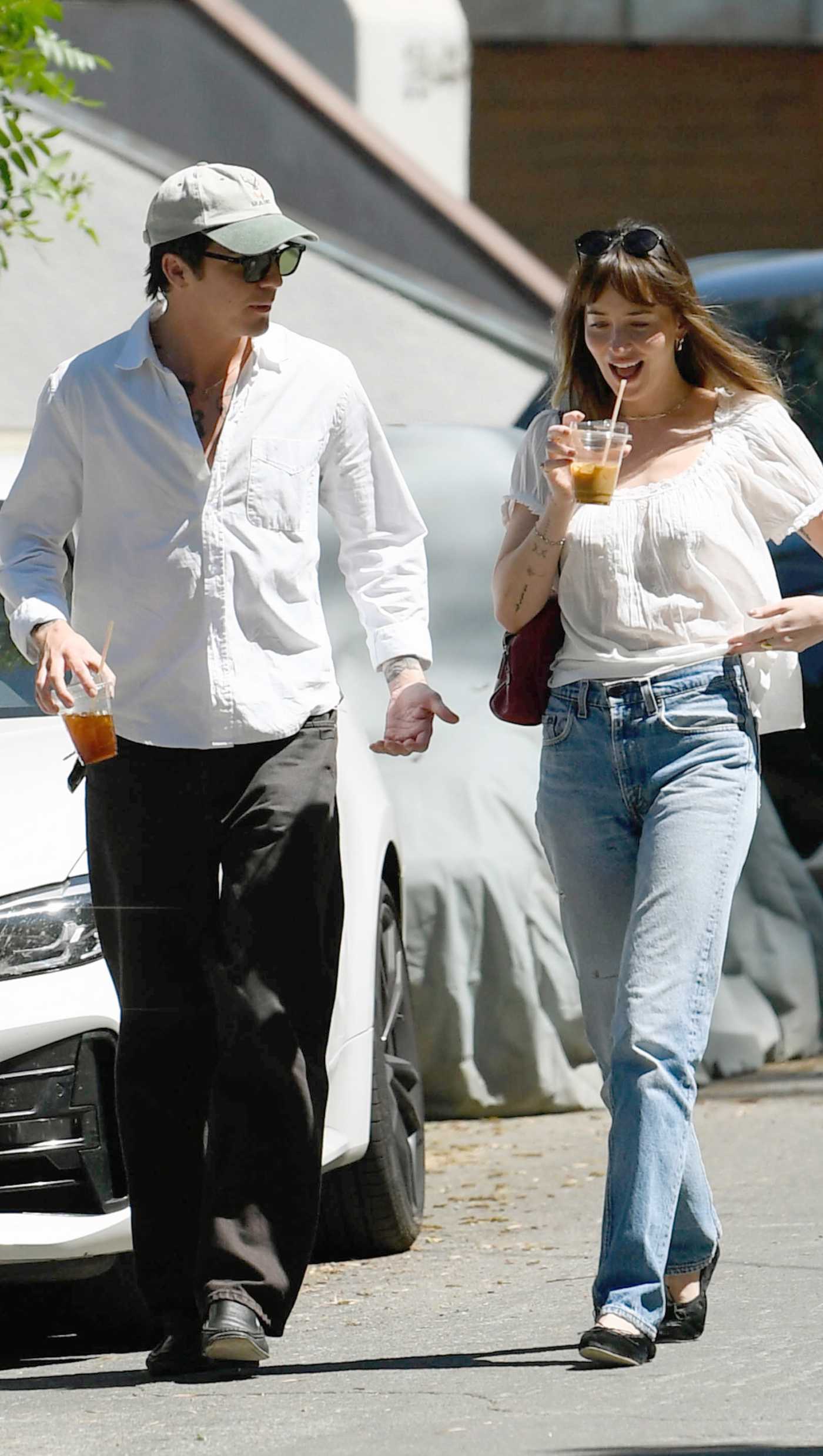 Dakota Johnson in a White Blouse Walking with Tucker Pillsbury to a Party in Los Angeles 04/05/2026