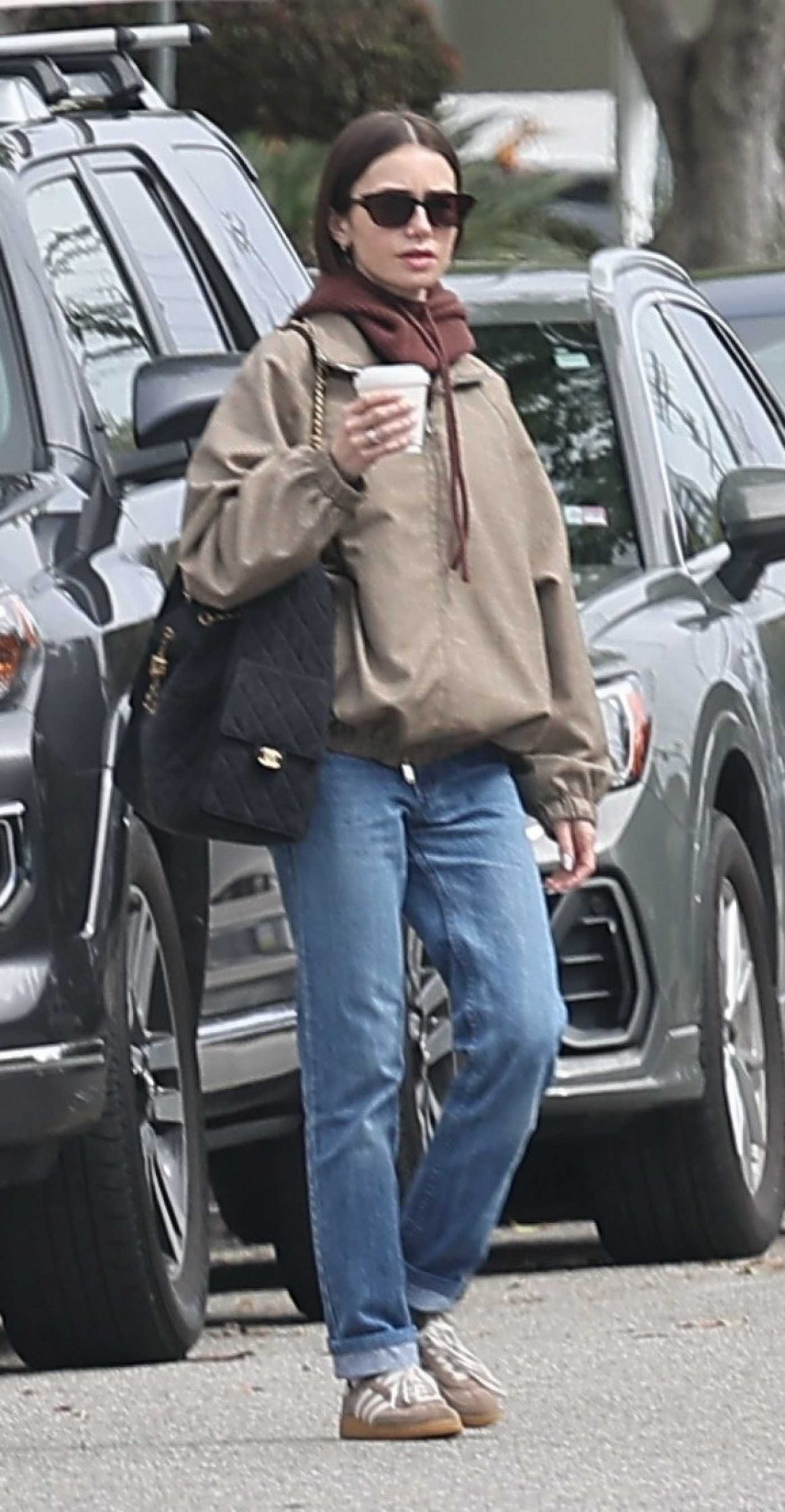 Lily Collins in a Beige Jacket Goes Shopping with Charlie McDowell at the Brentwood Country Mart in Los Angeles 04/13/2026