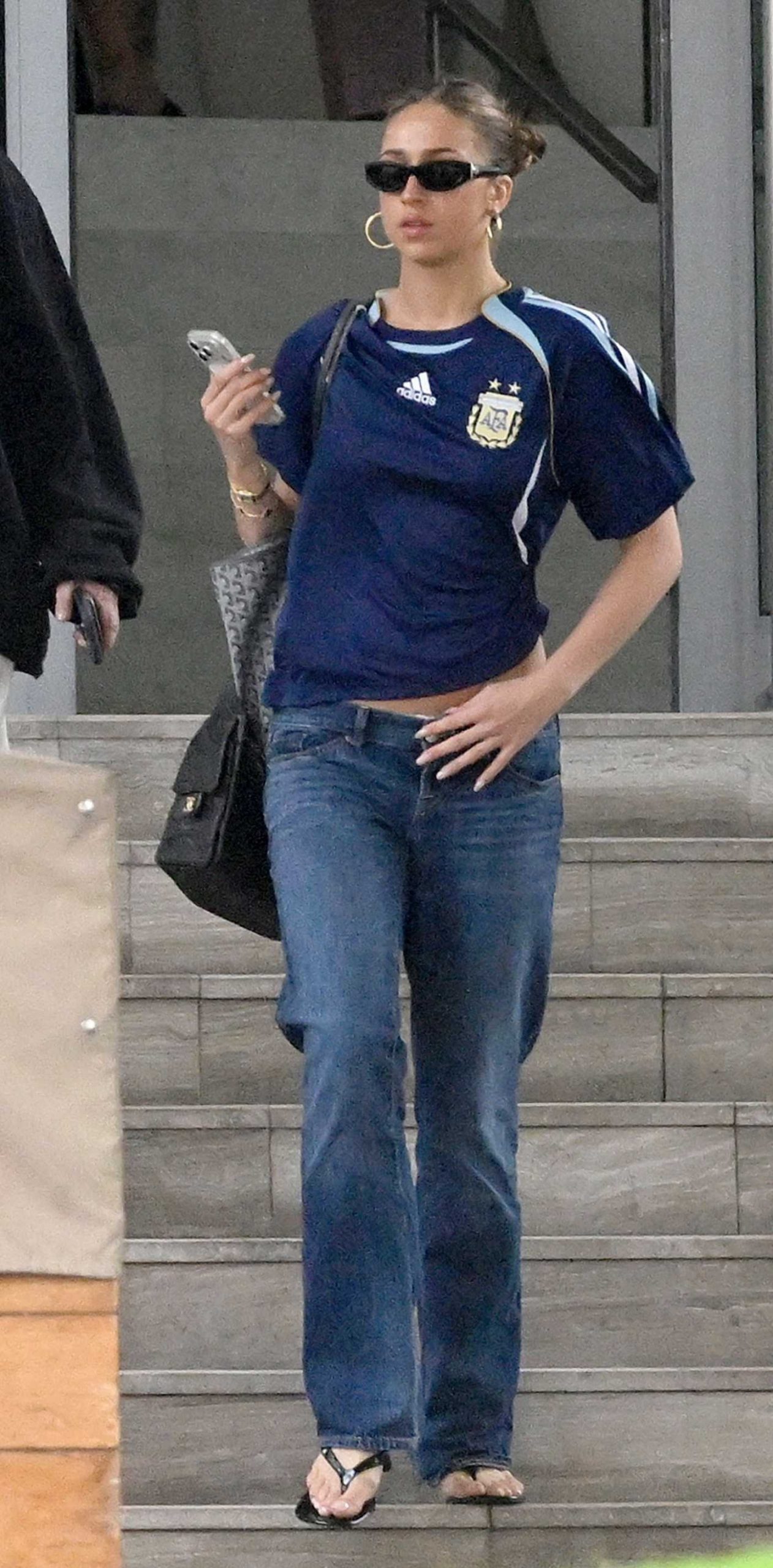 Tate McRae in a Blue Tee Leaves Her Hotel in Miami 04/09/2026